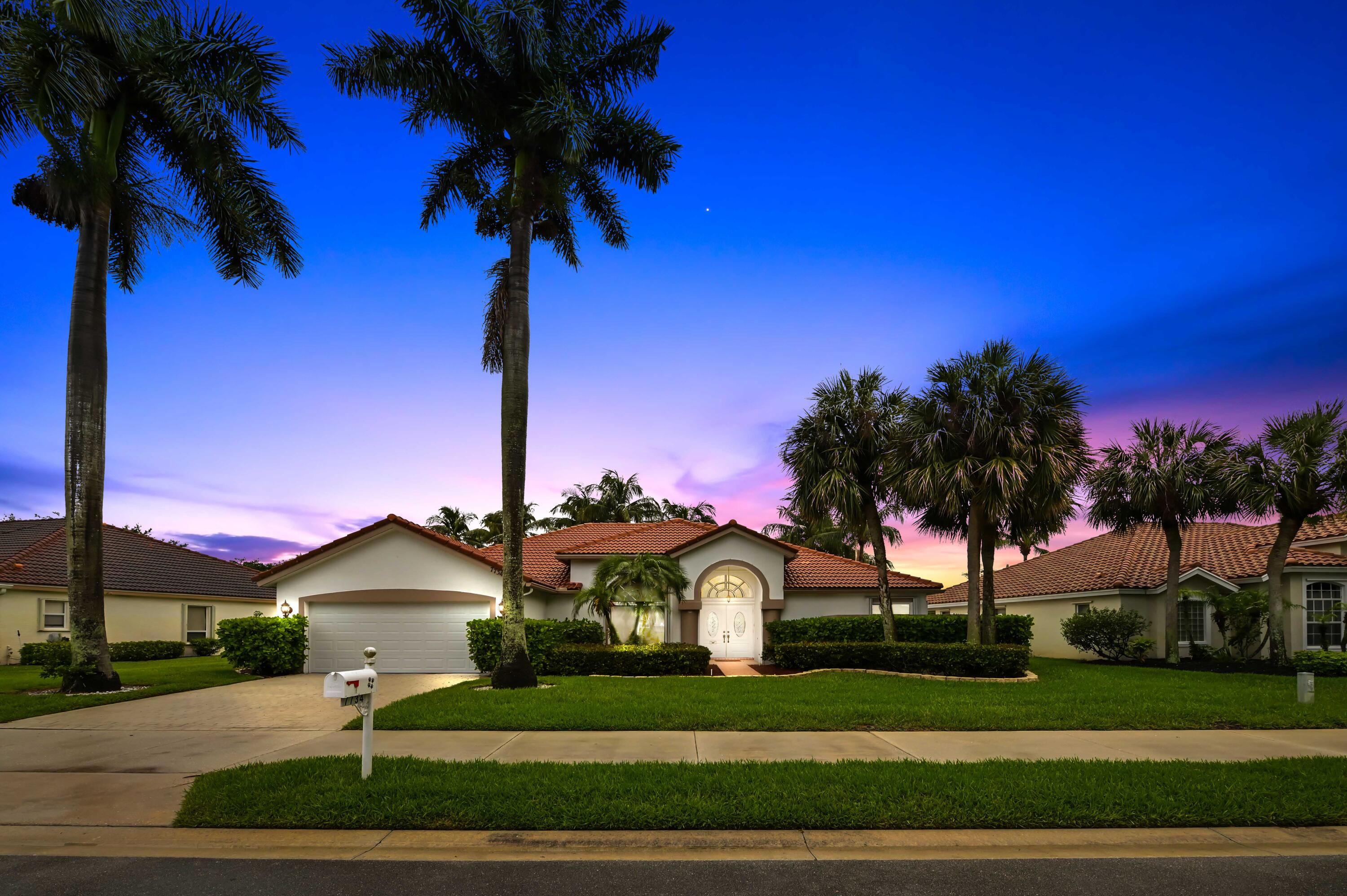 Welcome to this beautifully maintained pool & lakefront home nestled in the highly sought-after Lake Charleston community in Lake Worth. Offering over 2,400 square feet of living space, this spacious 4-bedroom, 2.5-bath residence features an open and airy split-bedroom floor plan with soaring vaulted ceilings, abundant natural light, and elegant living spaces designed for both comfort and entertaining. The oversized family room flows seamlessly into the kitchen and breakfast area, while formal living and dining spaces provide the perfect setting for gatherings and special occasions. From the moment you step inside, you'll appreciate the thoughtful details throughout, including tile flooring, tray ceilings, French doors, built-in shelving, impact windows, and generous walk-in closets. The spacious primary suite offers a relaxing retreat with dual sinks, a Roman tub, and separate shower. Step outside to a large screened patio overlooking tranquil lake views — an ideal backdrop for morning coffee, sunset dinners, or simply enjoying the peaceful South Florida lifestyle.   Situated on a beautifully landscaped lot with a 2-car garage, this home is located in a quiet, established neighborhood known for its top-rated schools, scenic walking paths, community pool, tennis courts, and convenient access to shopping, dining, and major highways. Combining timeless charm, generous living space, and serene waterfront living, 7734 Belmont Dr is the perfect place to call home.