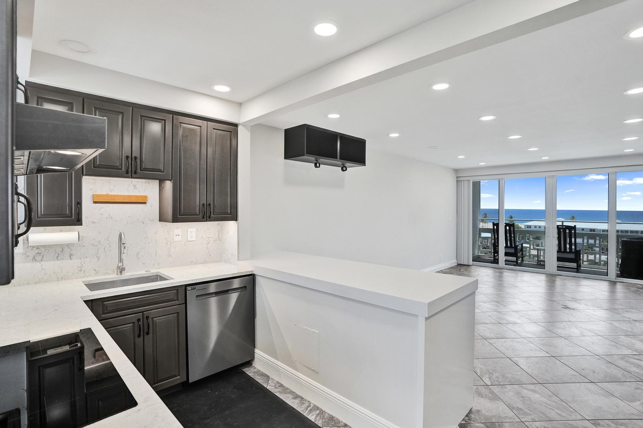 Priced to sell! Wake up to breathtaking direct ocean views at Breakwater Tower. This beautifully renovated 1-bedroom, 1-bath residence offers 805 sq. ft. of turnkey living just steps from the beach. Enjoy your morning coffee on the private balcony while taking in endless ocean views, also visible from the bedroom. Features include tile floors, a renovated kitchen with gray cabinetry, white quartz countertops, stainless steel appliances including a refrigerator, wall oven, microwave, dishwasher, and glass cooktop, plus a renovated bath, recessed lighting, fresh white paint, central A/C, impact windows and doors, and custom bedroom built-ins. Community pool and renovated lobby. Move-in ready!