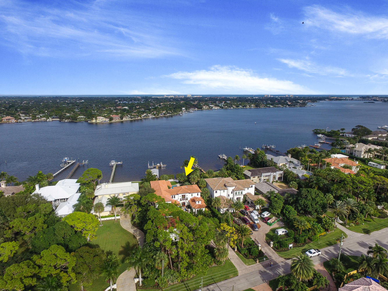 Gorgeous custom built gated riverfront estate in premium Jupiter location with amazing views. Newly updated, all impact windows & doors, elevator, Crestron Home Automation system with security cameras, lighting control & audio/video distribution. Courtyard entry fountain, formal living room with marble fireplace, new gourmet kitchen with 2 islands, Thermador 48'' gas range, butler's pantry, formal dining room, full bar/beverage center, 1st floor master suite and office. Spacious covered loggia with summer kitchen, heated saline pool & spa, gas fire pit, sandy beach for easy water access to kayak & paddleboard. Dock with 20K lb electric boat lift, jetski lift, rare boathouse for all your fishing/boating storage & for just hanging out. Separate guest apartment above garage and 20KW generator