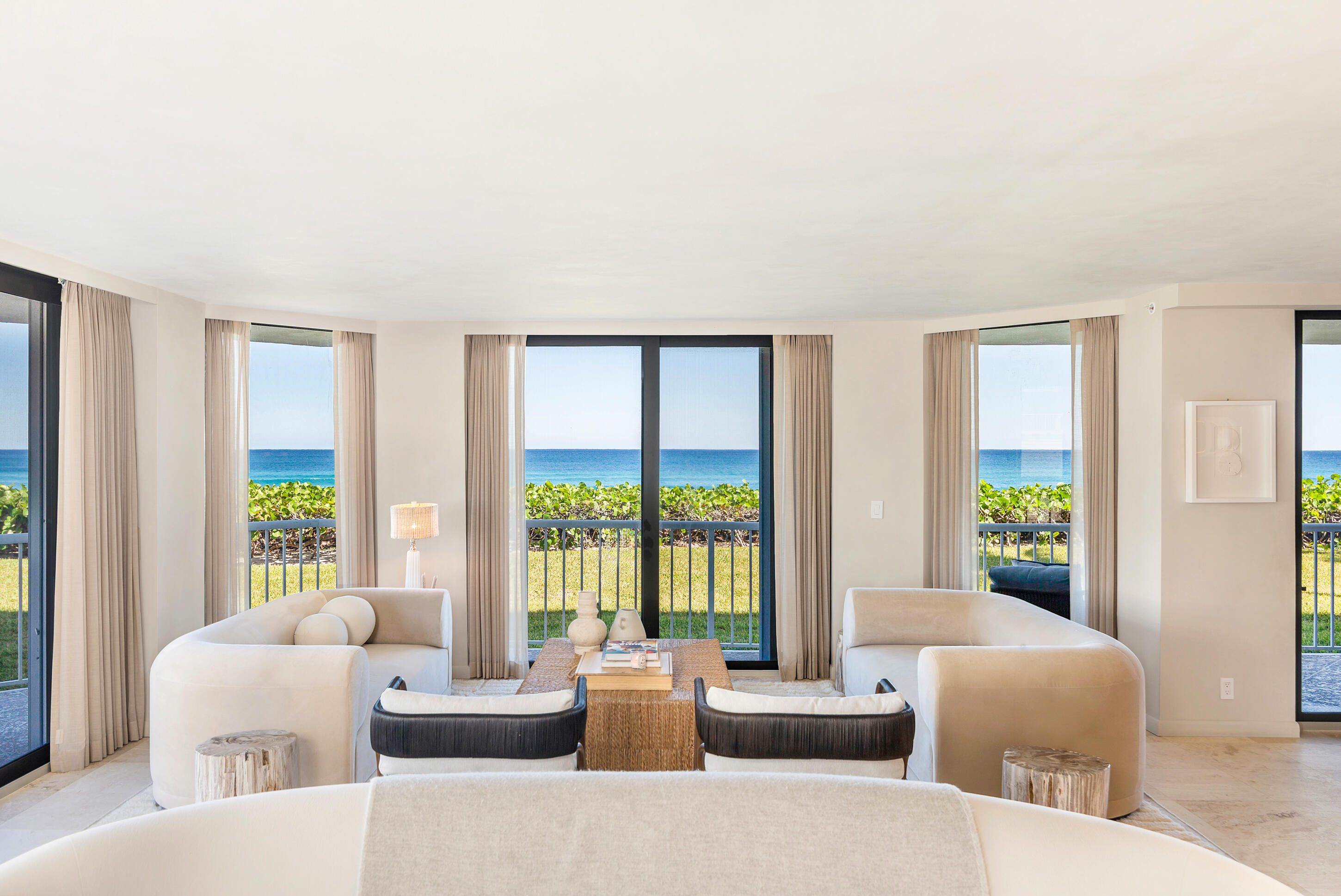 Located directly on the ocean in the prestigious Enclave building on South Ocean Boulevard in Palm Beach, this beautifully designed residence was created by renowned interior designer Noa Santos.  The three bedroom, three bath condominium offers 3,577 total square feet of sophisticated living space with exceptional craftsmanship and high-end finishes throughout. The expansive open living and dining areas are designed for both comfort and elegance, with floor-to-ceiling glass doors that fill the space with natural light and frame the breathtaking ocean views. A wraparound balcony allows for a seamless indoor-outdoor flow with views of the lush green space extending to the Atlantic Ocean creating a serene setting for relaxing and entertaining. The gourmet kitchen is equipped with top-of-the-line Miele appliances, including an oven, microwave combo oven, and stovetop, complemented by a Liebherr refrigerator and freezer. A custom coffee bar and a sophisticated wet bar with an ice maker, fridge, and fluted paneling enhance the home's refined entertaining spaces. A grand entryway and a spacious front hall closet add to the home's thoughtful design. The primary suite is a private retreat featuring two walk-in closets, a built-in desk, a linen closet, and a dedicated shoe closet. Wood floors add warmth and elegance, while terrace doors open to stunning ocean vistas. The spa-inspired primary bath includes dual sinks, a walk-in shower, a separate soaking tub, and a private water closet with a toilet and bidet. The guest suite offers a walk-in closet, an en suite bath with a walk-in shower, and private balcony access with ocean views. The third bedroom opens out onto the terrace with stunning views of the water. An additional bath features a custom vanity and a reeded glass shower enclosure. Additional conveniences include a spacious laundry room with a sink, hanging space, and ample storage, as well as a large front hall closet. Full hurricane doors ensure security and peace of mind, while a Trane A/C system and a water purification system add to the home's modern comforts. The Enclave offers resort-style amenities, including a pool, hot tub, grilling area, tennis court, a state-of-the-art fitness center, and a beautifully appointed party room with a bar and card area. The building also offers a 24-hour doorman and security, a full-time on-site manager, and a gated entrance.  Additional features include two garage parking spaces, bike storage, and a private air-conditioned storage unit.