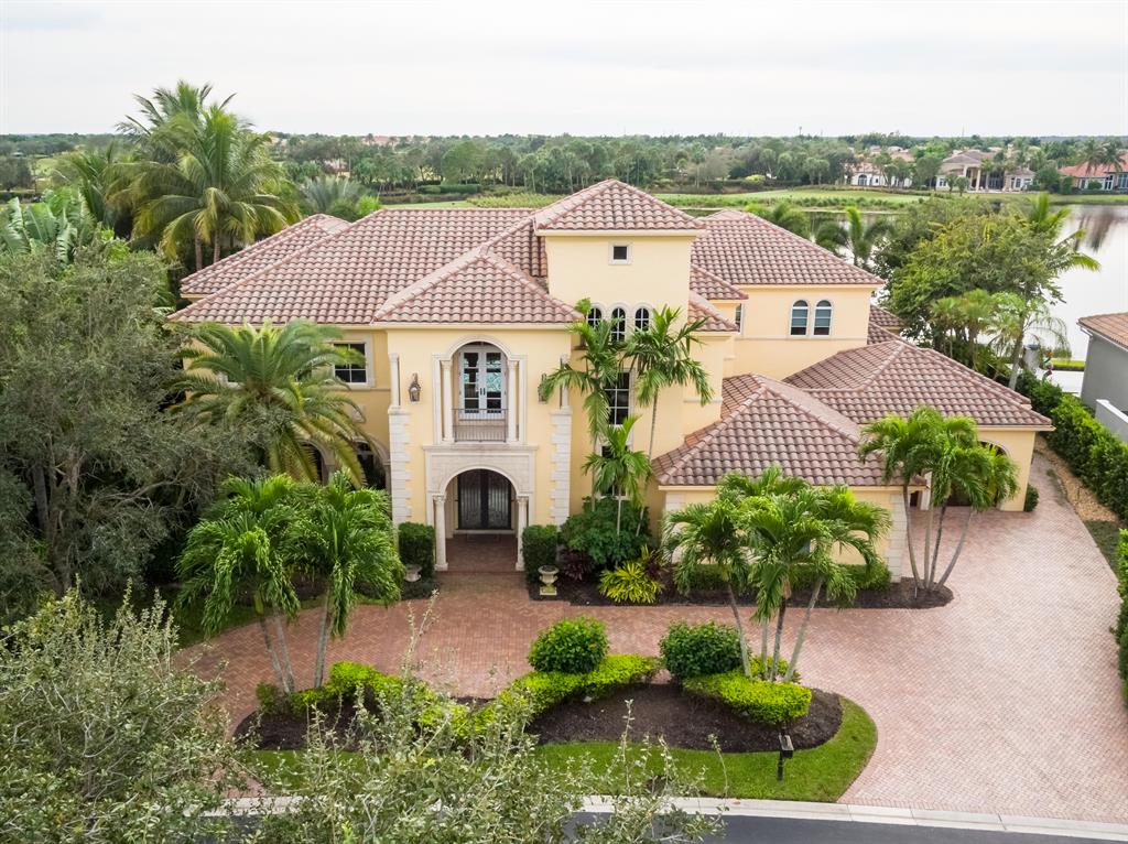 Magnificent estate home on one of the large lakefront lots. This home has spectacular views. To your right are unbelievable sunsets and straight ahead is a private view of the golf course across the wide lake. This home has over 8,400 square feet boasting 6 bedrooms, 7 bathrooms, 2 laundry rooms (up and down), a loft, office, theater room and a 4 car garage plus golf cart entry. Huge open floor plan with large kitchen, lots of cabinetry with butler's pantry, large master suite with sitting room, upstairs loft, most bedrooms with view of the lake. Infinity pool and spa, fountain, outside fireplace and summer kitchen. Don't miss this one!