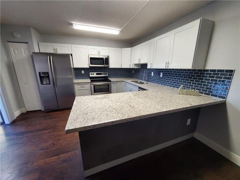 Fully remodeled 2 bedrooms and 2.5 bathroom townhouse located in the highly sought-after community of Woodvale at Pine Ridge in Davie. brand new kitchen, Stainless steel appliances, Granite countertops, and kitchen peninsula covered with luxury and sophisticated leather tiles! New water heater and new AC unit system, laminate flooring throughout, new light fixtures, Washer and Dryer, spacious bedrooms, each with its own private bath, large walk in closet in master. Private fenced patio. Just a few steps distance to the community pool. Enjoy the country club living including a fitness center, heated pool, golf course, tennis courts, two restaurants and more. Amazing lifestyle at an affordable price! Grade A schools, great family-friendly neighborhood.