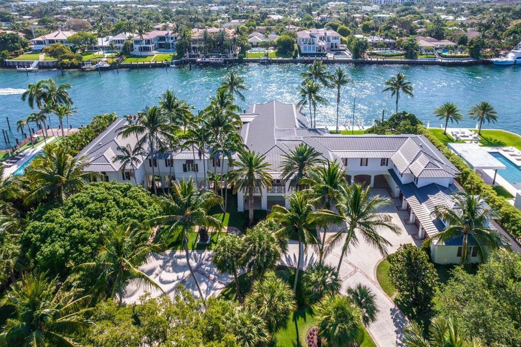 Magnificent, private, gated compound in East Boca Raton. This estate home sits on 1.7 acres of land and features 225ft of dockage in a no wake zone. Special features include fortress-like construction,  2 bedroom guesthouse, covered boat slip for a boat up to 30ft, porte-cochère, summer kitchen, gazebo, large resort style pool with sun shelf, office, media room, clubroom, large open kitchen with wolf and subzero appliances,  large covered loggias for entertaining, elevator, generator, wine room, expansive private master suite and so much more.