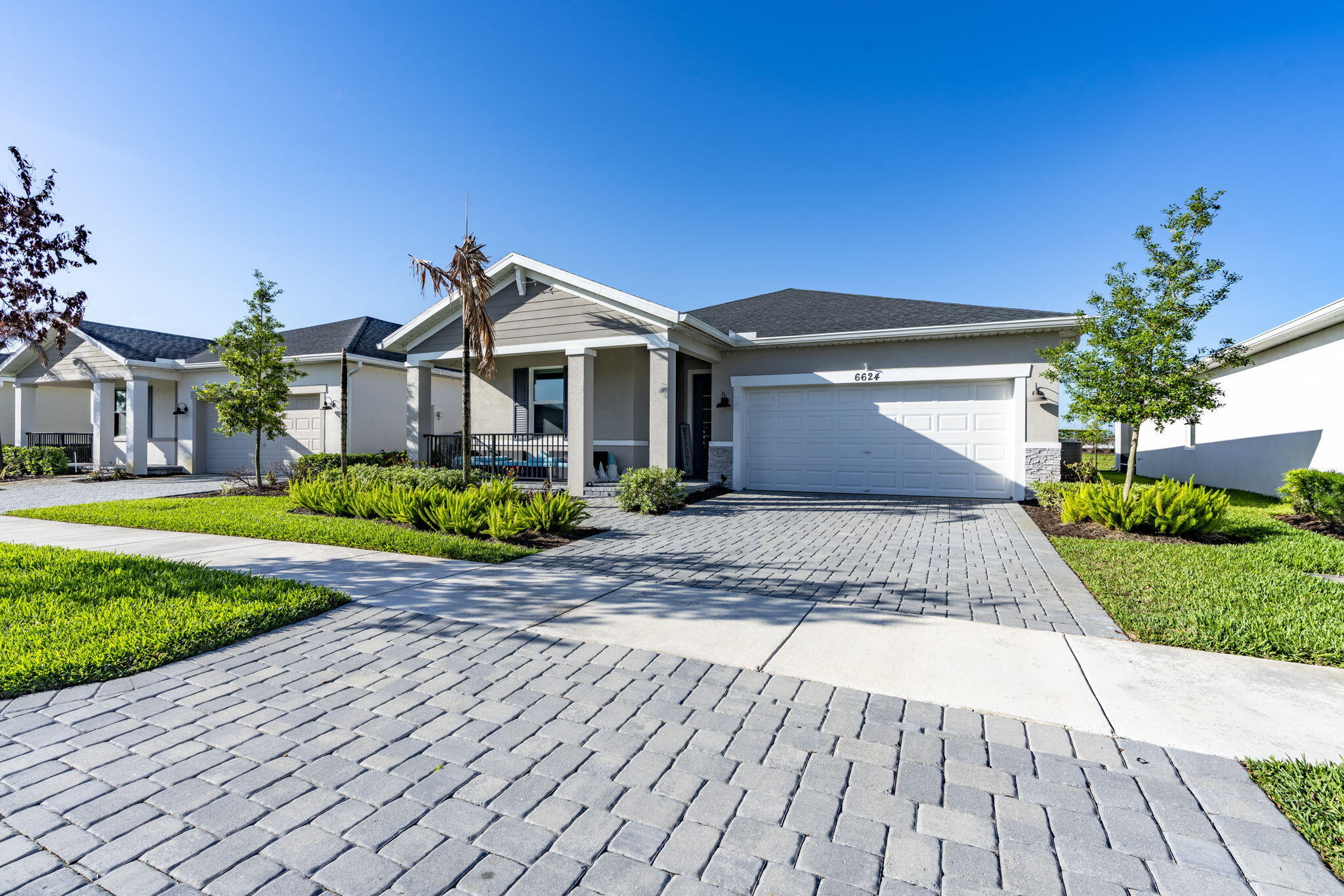 Welcome to this beautifully designed 2023 Meritage home in the sought-after Wylder community of Port St. Lucie. This 4-bedroom, 2-bath home features an open-concept layout, split floor plan, and energy-efficient construction. Enjoy impact windows and doors, whole-house gutters, and a spacious kitchen with a large island flowing into the great room, perfect for everyday living and entertaining. Relax year-round on the covered lanai. Built with high-efficiency systems for comfort and savings. Community amenities include a cabana, pickleball and tennis courts, trails, and lakefront areas. HOA dues include watering and maintaining landscaping . Conveniently located near shopping, dining, and major routes. Washer, dryer, and refrigerator do not convey. Schedule your showing today!