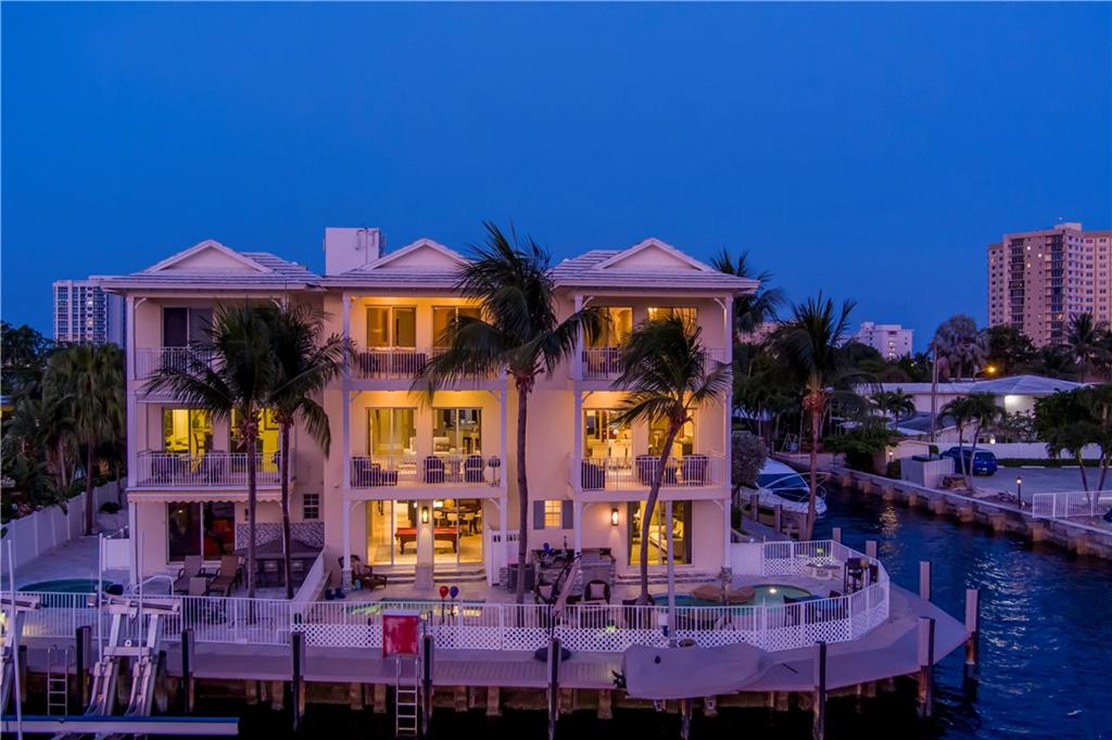 Intracoastal Point Townhome with spellbinding, wide water views of Lake Santa Barbara. Enjoy 3 levels of luxury living in this combined double townhome with re-imagined interiors featuring 3 bay garage, Bose Sound System, elevator, custom lighting, security cameras, two kitchens, impact windows & custom wine display. Luxe master suite features sitting room, two private balconies, 4 walk in closets and two bathrooms. Outdoor entertainment is enjoyed at the resort style patio with built-in bbq, spa & splash pool. Ideal for the avid boater with wraparound waterfrontage outfitted with two assigned docks including (1) 50’ Intracoastal Dock and (1) 39’ Canal dock minutes to the Hillsboro Inlet. Conveniently located within a short distance to the beach and nearby world-class restaurants.
