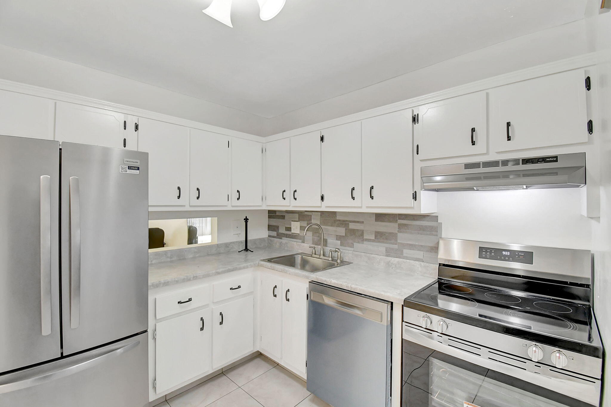 Welcome home! This move-in ready 1 bedroom, 1.5 bath condo is tucked inside a beautifully maintained 55+ community and has all the charm and functionality you've been looking for. Step into a bright and welcoming first-floor unit with easy-care tile floors throughout, a practical kitchen with warm wood cabinetry and newer appliances, and roomy closets that keep everything tidy. The French door entry into the primary bedroom adds a touch of West Coast flair—clean, airy, and effortlessly stylish. The primary bathroom features a refinished combo tub and shower for a fresh, clean look. The enclosed Florida room—with brand new blinds—offers extra space to relax, read, or entertain. Plus, you're just steps from the laundry room for everyday convenience. Newer AC, too! Enjoy the perks of a vibrant community with a heated pool, clubhouse, and plenty of social activities to keep things fun. You're also just minutes from shopping, dining, and all the essentials. This is low-maintenance living with a splash of style come see it for yourself!