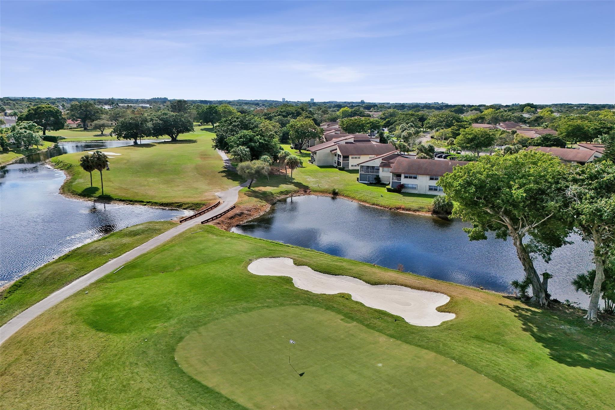 Wake up to peaceful golf course views in this beautifully updated 3BR/2BA first-floor residence. Gourmet kitchen featuring granite countertops, brand-new  top of the line stainless steel appliances, professional fresh paint, a new hot water heater, new disposal and spacious open living areas. The luxurious primary suite offers a sitting area, walk-in closet, and Roman Jacuzzi tub. Relax year-round in the covered, glass-enclosed Florida room overlooking the fairways. Community pool, pet-friendly community, and all assessments paid in full. A true lifestyle upgrade in sought-after Woodmont!