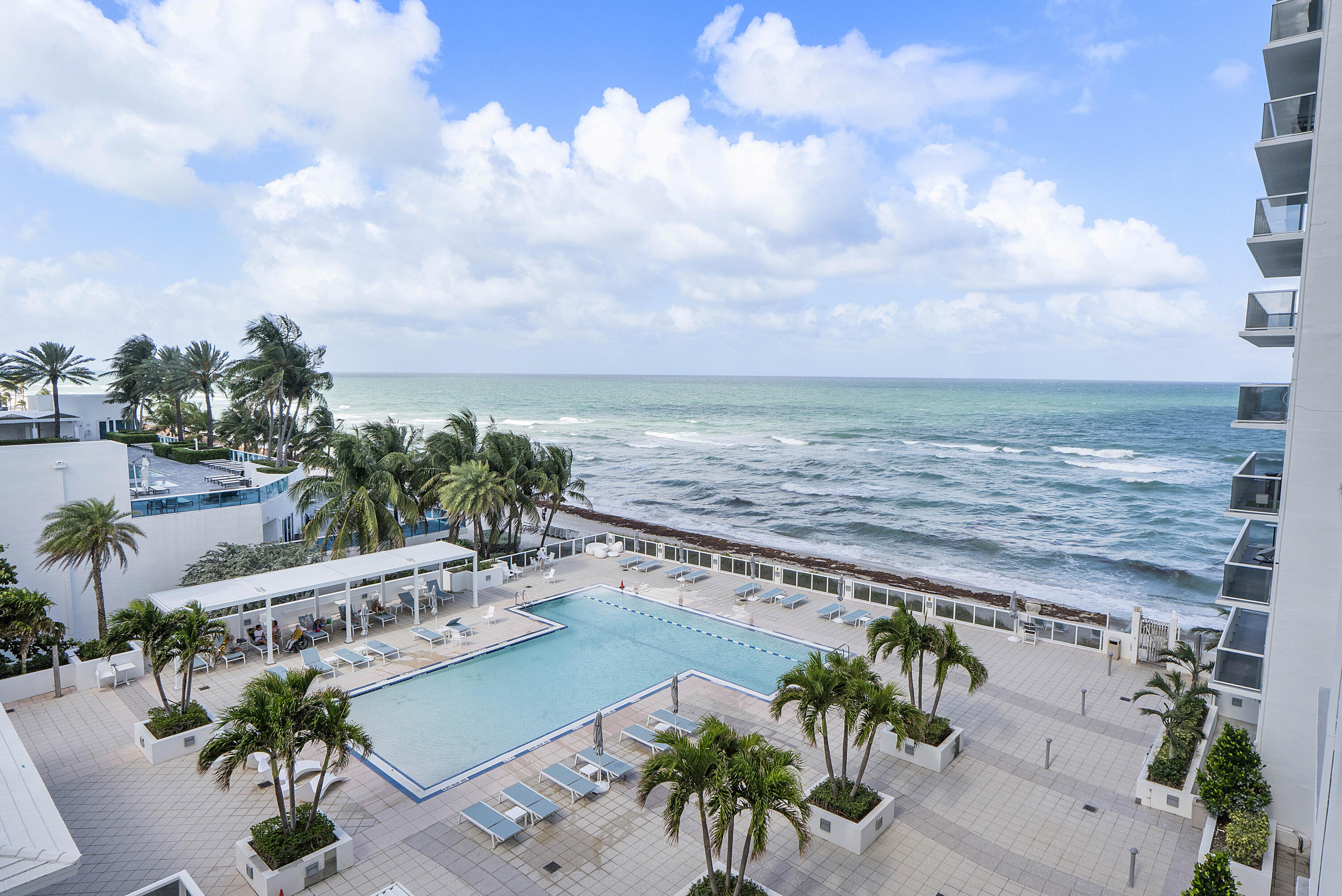 Imagine waking up to the gentle sound of ocean waves and tracking the morning sun across elegant porcelain floors.  This beautifully elevated 6th floor residence offers pool and ocean views from every room. Your day begins with a workout in the beachfront gym, a rejuvenating session in the private saunas, or a dip in the heated pools. Spend afternoons with your toes in the sand, enjoying complimentary beach chair and umbrella service just steps from your secure gated entry.  Located on the narrow barrier island near vibrant US-1 dining, this 1,360 sq. ft. beach getaway perfectly blends serene resort living with urban convenience. Fully secured building with valet and concierge. Welcome home. ALL SPECIAL ASSESSMENTS HAVE BEEN PAID IN FULL BY THE SELLER.