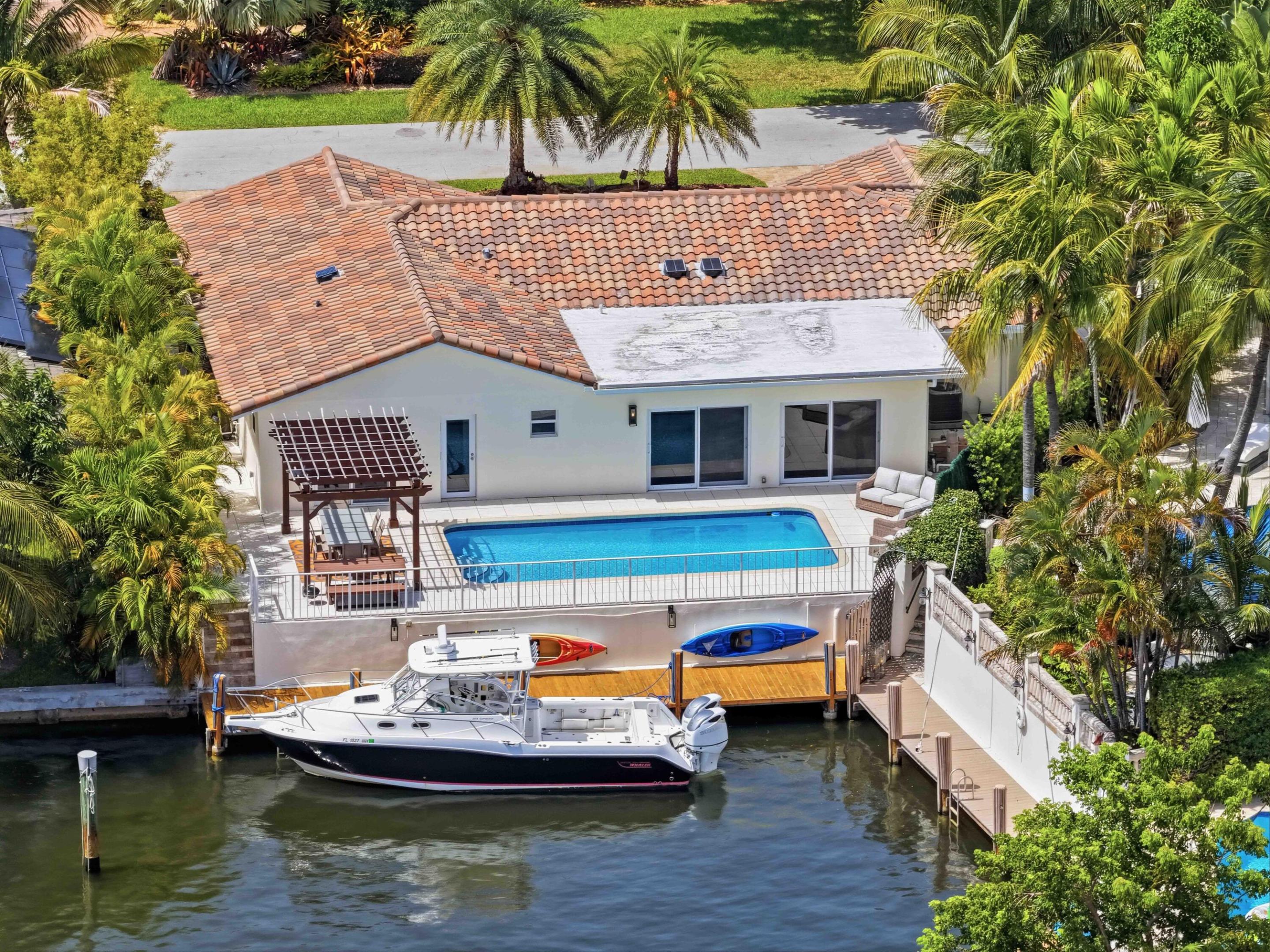 Welcome to this upgraded waterfront single-story residence in Fort Lauderdale Beach's desirable Bermuda-Riviera. This NO-Fixed bridge 4-bedroom, 3-bathroom home offers 2,640 sf of finished indoor space designed for comfortable modern living. The floor plan flows naturally across one level, w/ 2 living rooms & open kitchen making it easy to navigate & maintain. IMPACT Windows & Doors,Gorgeous Interior Mahagony doors & Marble Floors throughout. Beautiful Travertine Spacious U-driveway. Newer roof, A/C, slate facade, Porcelain Coral Back and side yard Patios. With a sparking pool, pergola & boat dock it's truly indoor-outdoor living. Two-car garage parking & direct ocean access, this property combines convenience with the appealing lifestyle that waterfront living in Fort Lauderdale provides. Marble Floors throughout.  Beautiful Travertine Spacious U-driveway.  Newer roof and a/c. No-Fixed Bridge waterfront. Also walk to the beach through private community entrance. 4th bedroom is currently configured as an office.   Please Click VIRTUAL TOUR to WATCH the drone Footage to fly through and above the home. Enjoy the  Incredible Tour.