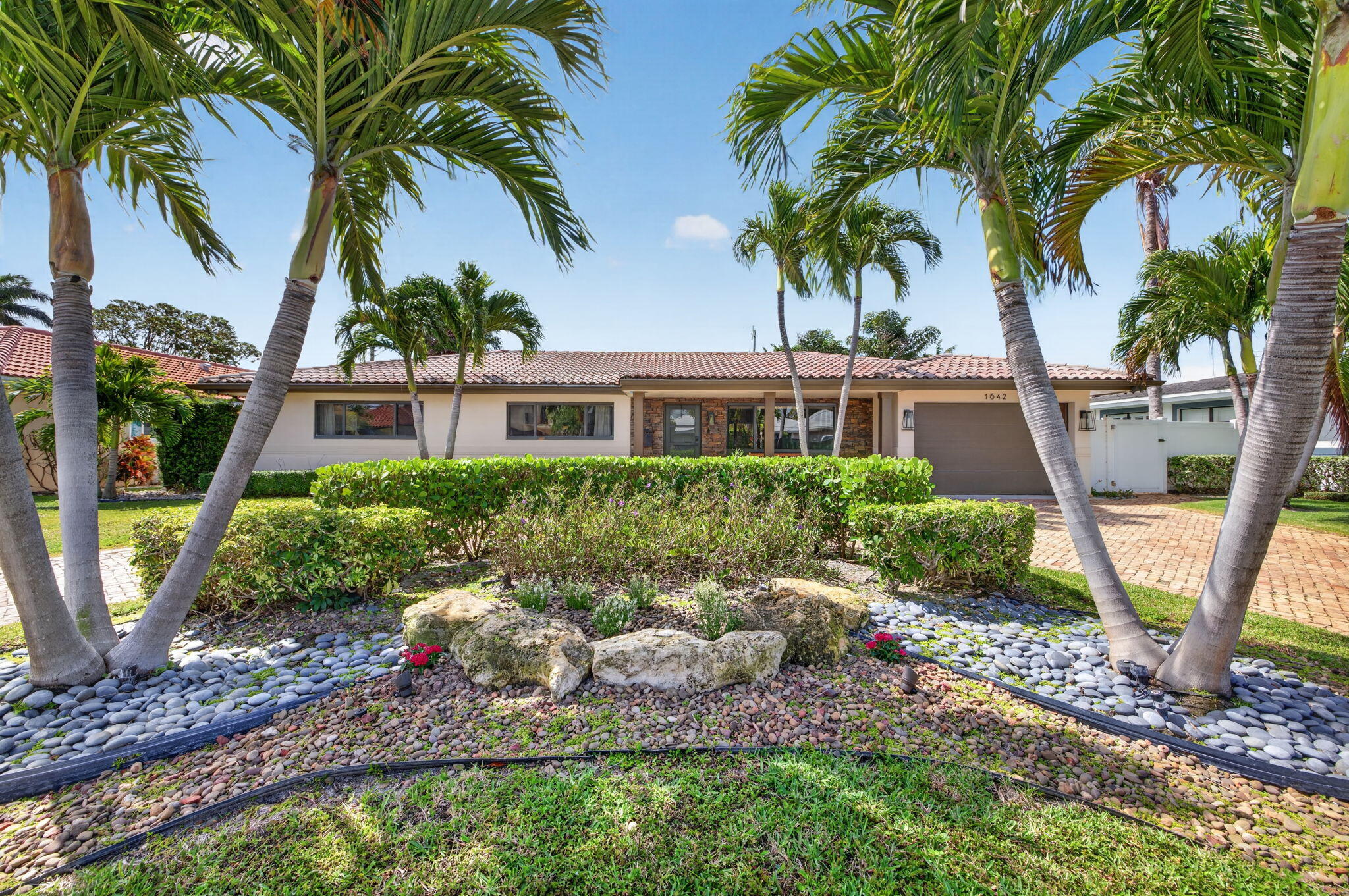 Welcome to your private retreat in the heart of the Cove in Deerfield Beach. This beautifully remodeled 3BR/2BA home (2017) offers expansive outdoor covered screened lanai with pecky cypress ceiling adding 800s/f  of living space overlooking the sparkling pool.  Thoughtfully designed interior features with wood-look tile flooring, impact windows and doors, and a Crestron smart home system. A chef-inspired kitchen boasts custom wood cabinetry, quartz countertops, and premium appliances including a Bertazzoni gas range and Liebherr refrigerator.  Security system including color cameras covering all exterior areas. Lush tropical landscaping and a 2024 Kohler generator enhance comfort and peace of mind in this move-in ready coastal oasis. A Must See