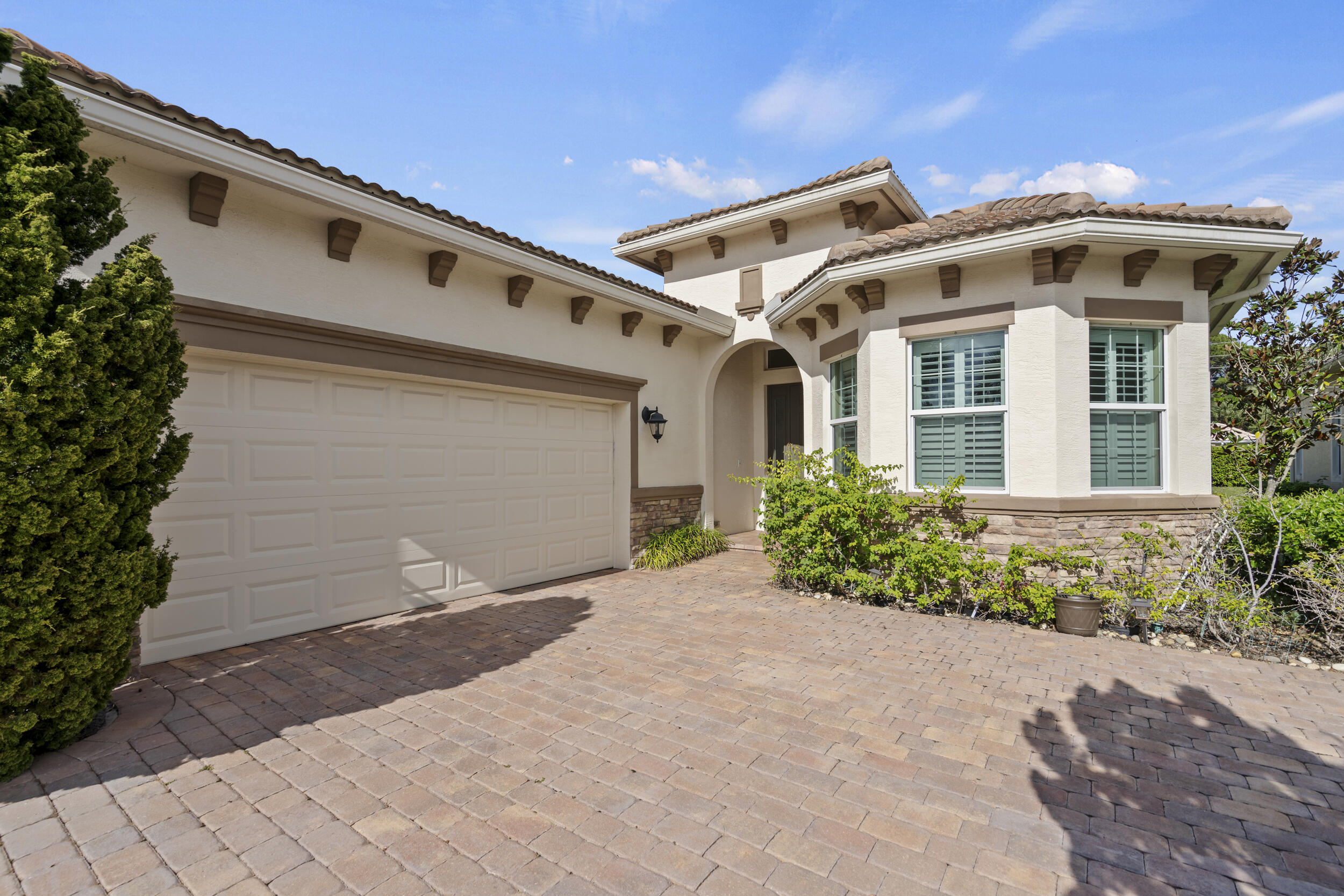 Stunning Isabella Model in PGA Verano featuring 3BR, 2 BA, and 2 Car Garage. This meticulously upgraded home offers impact windows, plantation shutters, rain-soft whole house water filtration /softening system, stainless steel appliances, luxury bidets in both bathrooms. Enjoy custom sliding vertical duets, extended back patio and lush landscaping. Allergy filters on central A/C, waterproof vinyl flooring in the bedrooms, tile floor in living/wet areas, window A/C unit in the garage, wood blinds and 3 storage ceiling racks and attic with plywood flooring. Includes a generator hook up for peace of mind. HOA amenities include an indoor and an outdoor pool, gym,54 HOLES FOR GOLF,  27 PICKLEBALL COURTS!! also has tennis courts, dog park, art/craft/card room, Clubhouse, and many more!!!