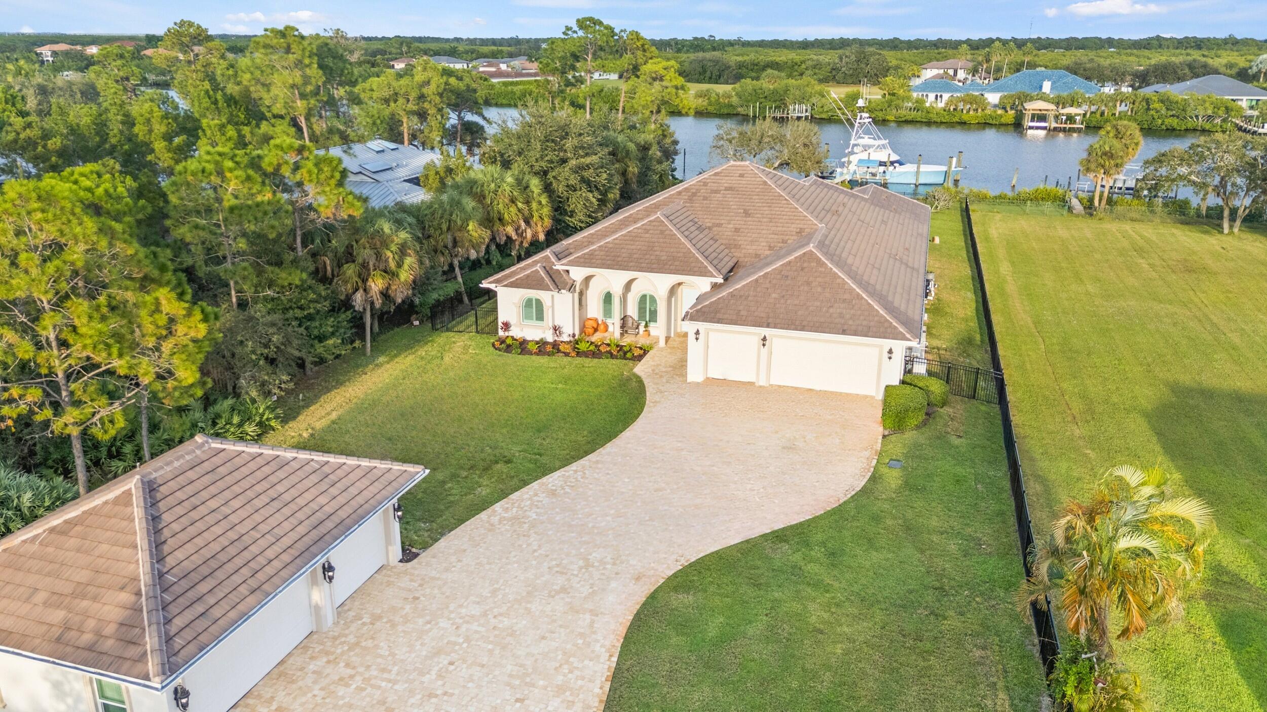 This architectural showpiece of coastal waterfront living delivers secure yacht ownership with a hurricane-hole-rated aprox 70' slip, deepwater ocean access, and over 1 acre in Vikings Lookout. Fully renovated from 2021-2025 with Thermador kitchen, gas cooktop, spa-quality baths, white oak floors, marble & quartz, custom smart and refined finishes. Close to 4,500+ living sq ft plus around 1,500 sq ft rare 6+ car A/C controlled garages -storage solutions/detached space opportunity. Resort-style outdoor oasis around 2000 sq ft under roof with infinity salt water gas & electric heated pool, Hestan kitchen, fireplace, new lanai, and Amish-built playground. New roof, impact windows, a whole house gas generator and water system. A home where your passions, pursuits, and people can converge.
