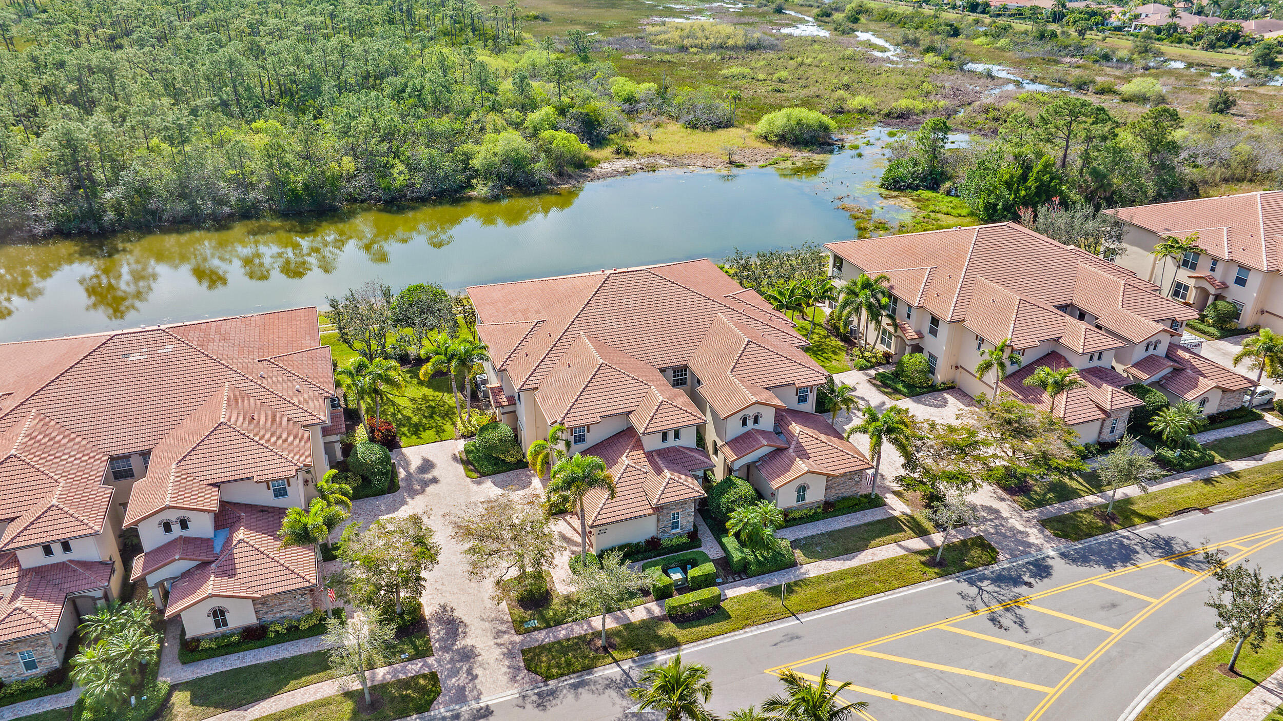 Completely reimagined in a sleek, contemporary style, this stunning Ventura model—the largest condominium floor plan in Ibis— offers an exceptional blend of scale, design, and tranquil lake and preserve views. Spanning 2,830 square feet with 3 bedrooms, 3.5 baths, and a den, this upper-level residence enjoys a coveted southern rear exposure, filling the home with natural light and showcasing peaceful natural vistas. From the moment you arrive, the new glass railing system (2023) sets a modern architectural tone, complemented by both a private elevator and staircase for ease and privacy. Inside, virtually every surface has been thoughtfully updated, creating a move-in-ready residence with a cohesive, contemporary aesthetic.  The great room is anchored by a striking custom stone feature wall with electric fireplace (2023), serving as a dramatic focal point for the open living space.  The primary suite has been fully transformed, featuring a completely redesigned bath with new flooring, vanities, tile, shower, fixtures, mirrors, and finishes—delivering a spa-like, modern retreat. Guest baths have also been upgraded with new countertops, sinks, toilets, and faucets (2023), ensuring consistency in both quality and design throughout the home.  The kitchen blends style and functionality with shaker-style cabinetry, granite countertops, glass tile backsplash, and stainless steel appliances, while additional upgrades include new door hardware, designer lighting, and ceiling fans throughout (2023). Each bedroom offers en-suite privacy, complemented by a versatile den/office, powder room, and full laundry room.  Expansive sliding doors lead to a private balcony where serene lake and preserve views create a peaceful backdrop for everyday living.  Located within The Club at Ibis, residents enjoy access to a 90,000-square-foot clubhouse, three Nicklaus-family championship golf courses, five dining venues, a world-class fitness center and spa, and premier tennis and pickleball facilities.  A rare opportunity to own a fully renovated, contemporary residence of this scale—where design, light, and setting come together seamlessly.