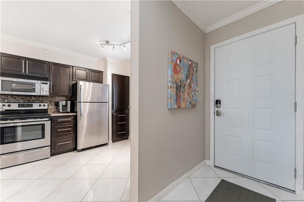 Step inside this must-see desirable condo in Cypress Bend. Located on the 6th floor, near elevators. As you walk inside, immediately notice the open gourmet kitchen with granite tops and deep rich chocolate cabinets with soft close doors and stainless steel appliances. As you flow into the living room, notice the french doors that lead out into your private balcony overlooking the garden, pool, and lake views- "The Ultimate Trifecta". AC-2012 with UV light, newer water heater-13', Nest AC thermostat, newer carpets in large bedrooms. Bathrooms were slightly remodeled and recently reglazed. New washer & dryer. Hurricane impact front door & all impact windows with UV protection, installed in 2019. Hurricane shutters are in place as well. Large storage, bike room, and fitness center.