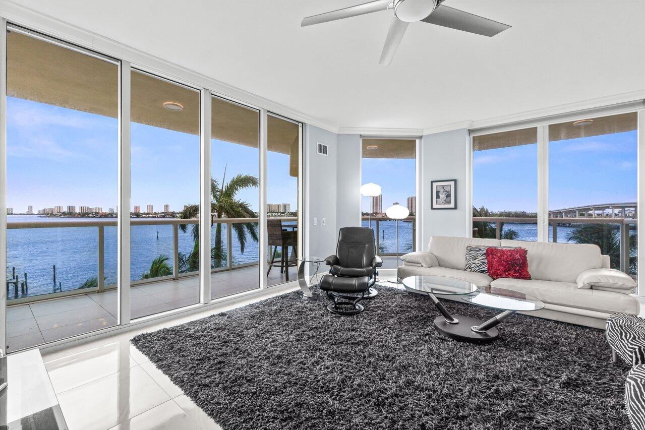 Rare end unit w 3BR + den/media, 3.5BA, only floor plan w/wrap around balcony overlooking the Intracoastal. New quartz kitchen w/KitchenAid & Frigidaire appliances, wine cooler. Every bedroom has an en suite bathroom! Open concept, neutral colors, beautiful white tile floors thru-out, crown molding, electric blinds, plantation shutters, his/her walk-in closets, split floor plan. Impact glass, semi-private elevator access. Assigned garage parking & climate-controlled storage unit. 24/7 Manned gate, valet, NEW covered rooftop oasis w/pool, spa, BBQ areas, tennis, pickleball, bocce. Clubhouse, fitness center & billiard room. Adjacent dry dock marina, no fixed bridges, minutes to ocean.  Waterfront walking path w/gazebo, pet friendly. social community!  Offered fully furnished.
