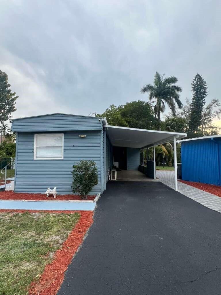 Charming Mobile Home in a community for all ages in Palm Beach Colony,  Beautiful and comfortable 4 bedrooms and 3 bathrooms, with elegant tray ceilings with wood accents, recessed lighting, and luxury laminate flooring, a private retreat with a double vanity spa-style bathroom, spacious covered front porch for relaxing, and private carport. All measurements are approximate. This property is available for purchase with Financing or Cash.  Call the listing agent today to schedule your private tour.