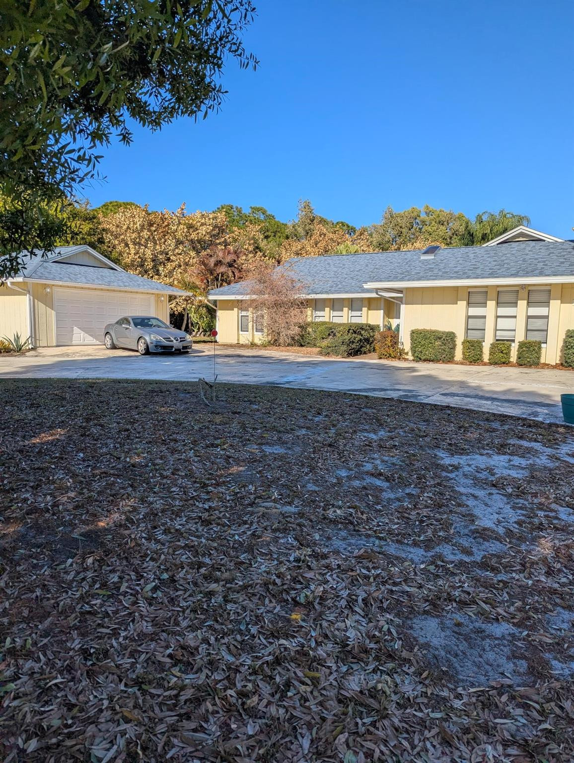 Private Florida oasis! This stunning 3-bedroom, 2.5-bath single-family home offers 2,200 sq ft of bright, comfortable living space on over a half acre fenced corner lot.Gorgeous screened-in pool with new screen enclosure & rock waterfallNew roof (house & garage) + 3 new sky lightsHuge circular driveway. Park 10+ carsDetached 2+ car garage with A/CBig living room with vaulted ceilings & cozy stone fireplaceBig bright kitchen with huge island and pass through window to poolFormal dining room for holidays & gatheringsMassive bonus room with its own separate entrance and half bath – easily convert to a 4th bedroom, playroom, den, or mother-in-law suiteCabana bathroom with shower leading to pool.Fenced yard with mature fruit trees and tall privacy hedges. Great layout & location.