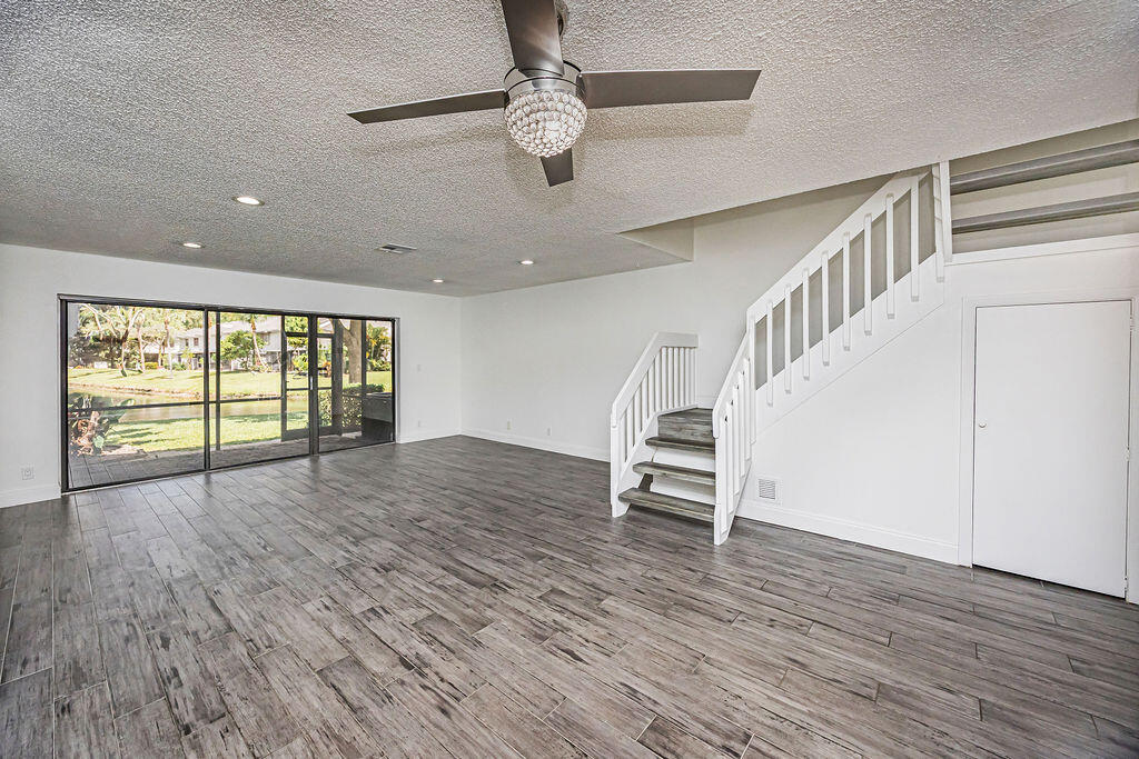 Beautifully remodeled, lakefront townhouse located in desirable Township community offering tons of amenities! This unit features Laminated floors throughout the downstairs, updated kitchen featuring new S/S appliances, beautiful Modern cabinets Black Quartz countertops w/tile backsplash. New modern lighting, including high hats. 1/2 bath has also been updated including a designer tiled wall (floor to ceiling.) Full size W/D. Upstairs features vaulted ceilings. Master BR offers lg walk-in closet. This unit has a beautiful lakefront view which can be enjoyed from your screened & covered patio. Pet friendly community (2 pets <30lbs.) Great location, unit facing East. Great community-10 tennis courts, basketball courts, full Theatre, state-of-the-art gym, aquatic center, ballroom & more!  no rent until 2 year ownership 2 Home owners associations include Golden Raintree iVand Township.Town home conveniently located  close to FL Tpke , 441 and Sawgrass Hway. Promonade Restaurants, Cinema and shopping close by.
