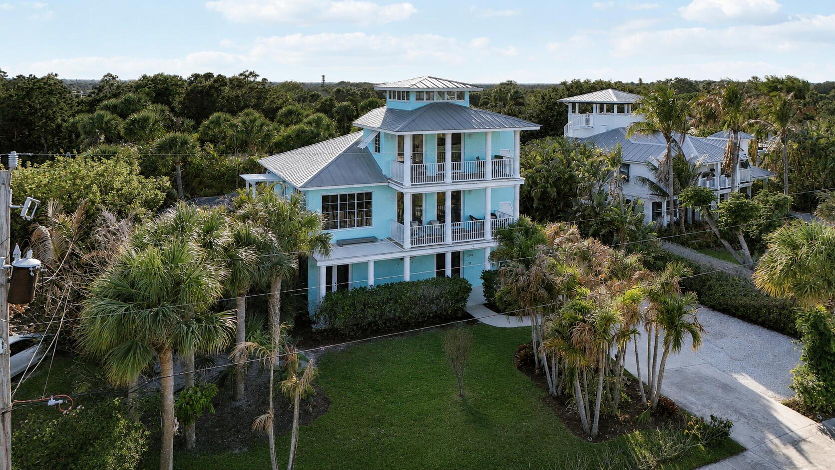 Exceptional opportunity to own this Key West style home on the highly desirable Skyline Dr! This property sits high and dry on one of the highest points in the county offering not only the advantage of never having to worry about flooding but also perfect to enjoy the tropical breezes and amazing panoramic views! The layout here is exceptional for entertaining with three ensuite bedrooms each on their own floor.  The property has been significantly updated since purchasing including refinished hardwood floors, painting, new trex balcony, new pool heater, new washer/dryer, new dishwasher, many new and updating lighting fixtures and other details that embody a coastal atmosphere. This property is currently used as a part time second home and part time airbnb generating approx 80k+ in rev/yr! The location here can't be beat as its close proximity to downtown Jensen and under 5 minutes to the beach and countless other locations. Broker owned.