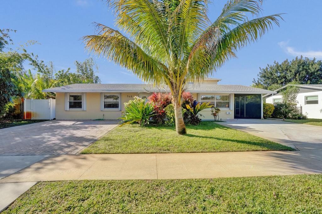 Rarely available, this beautifully renovated property offers a spacious one-story main residence paired with a detached two-story guest house—a unique combination of comfort, privacy, and flexibility. The main home features an open-concept layout with tile flooring throughout, 3 bedrooms, 2 bathrooms, and a beautifully updated kitchen with custom cabinetry, granite countertops, stainless steel appliances, and a generous peninsula with bar seating overlooking the living and dining areas. A separate den or office adds flexibility, while large windows fill the home with natural light. Step outside to your own private backyard retreat featuring a sparkling pool, expansive patio, fully fenced yard, and a covered outdoor kitchen with a built-in BBQ—perfect for entertaining or enjoying Florida's year-round outdoor lifestyle. The detached two-story guest house offers exceptional versatility with its own private entrance. The first floor includes a living room, bedroom, and full bathroom, while the second level features two additional bedrooms and another full bathroom. Ideal for guests, a private home office, creative studio, or additional living space, it provides the flexibility and separation rarely found in a rental property. Thoughtfully renovated throughout, this exceptional property offers beautifully updated living spaces, outstanding outdoor amenities, and a floor plan designed to adapt to a variety of lifestyles. Conveniently located near shopping, dining, golf, parks, and area beaches, this is a rare leasing opportunity in North Palm Beach. Being offered both furnished or unfurnished.