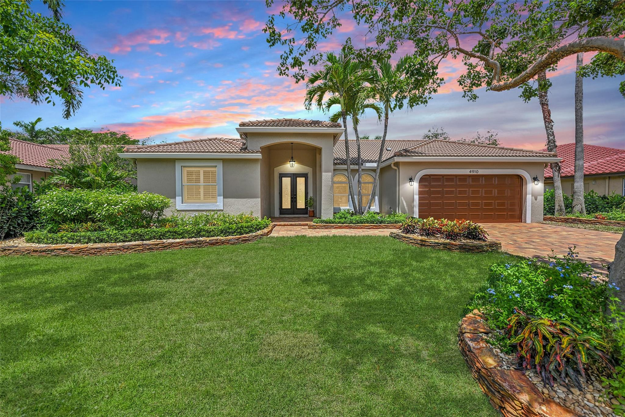 Is there a 5-bed pool home in Coral Springs with major upgrades and move-in ready finishes? This split 5-bedroom, 2.5-bath home at 4910 NW 104th Ave offers over $250K in upgrades, impact windows and doors, and a beautifully updated interior designed for modern Florida living. Great opportunity to own a fully upgraded 5-bed pool home featuring high ceilings, plantation shutters, and natural light throughout. The interior showcases engineered wood flooring in bedrooms and porcelain tile in main living areas. The brand new kitchen includes modern backsplash and stainless steel appliances, ideal for both daily use and entertaining. The primary suite offers a brand new ensuite with soaking tub, spacious shower, and walk-in closets. Lush landscaping and paved driveway to welcome you home!