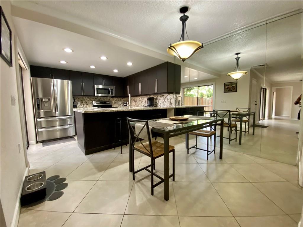 Nicely updated Town Home in Pine Island Ridge. Home features 3 bedroms (1 on the 1st floor) and 2.5 baths, granite countertops, S/S appliances, full size washer & dryer, accordian shutters, spacious storage area, fenced private patio, designated parking plus guest parking. HOA includes basic cable, roof plus building exterior, trash, sewer, plus lawn/landscaping maintenance. Community Clubhouse amenities include; Pool, Hot Tub, Tennis/Basketball Courts, Gym, Playground, Library, Billiards, Conference Rooms, Bar & Restaurant on site, and Community Golf Course.  2 Assigned parking spots plus ample guest parking. Minutes to 595, I-75, and the Sawgrass Expressway.  No Rentals 1st year owned. Nicely updated Town Home in Pine Island Ridge. Home features 3 bedroms (1 on the 1st floor) and 2.5 baths, granite countertops, S/S appliances, full size washer & dryer, accordian shutters, spacious storage area, fenced private patio, designated parking plus guest parking. HOA includes basic cable, roof plus building exterior, trash, sewer, plus lawn/landscaping maintenance. Community Clubhouse amenities include; Pool, Hot Tub, Tennis/Basketball Courts, Gym, Playground, Library, Billiards, Conference Rooms, Bar & Restaurant on site, and Community Golf Course.  2 Assigned parking spots plus ample guest parking. Minutes to 595, I-75, and the Sawgrass Expressway.  No Rentals 1st year owned.