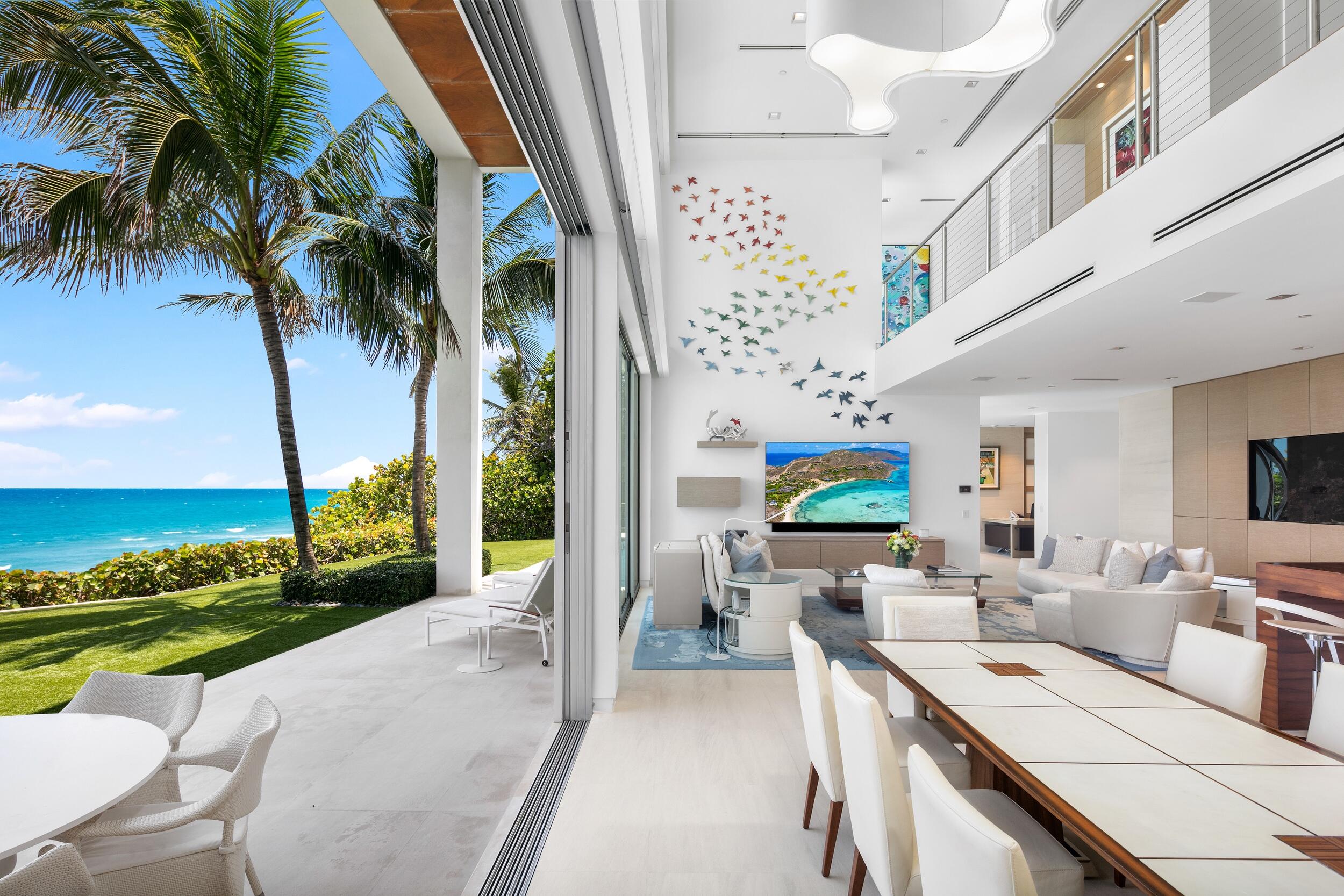 Oceanfront luxury has a new address. Welcome to Casa Blanca at 3719 S. Ocean Blvd in Highland Beach. 
This contemporary coastal gem is an ode to the luxurious lifestyle that Highland Beach has to offer. Casa Blanca offers innovative architecture that stirs the senses with a rare mix of contemporary splendor, artisanal craftsmanship and resort-style comfort. 
Completed by Cudmore Builders in 2016, this sprawling estate spans 12,791 SF across its multiple stories and features 100 FT of glittering ocean frontage. The impressive custom estate establishes an unmistakable regal tone. Upon entering the estate, one finds themselves enthralled by the panoramic ocean views and  bespoke sculpture by Raymond Karpuska. The great room wall also features a bespoke art installation by Karpuska, accenting the soaring ceiling in the living space with colorful swallows.
Interior spaces at Casa Blanca enchant with clean contemporary design by renowned Susan Lachance. Expansive windows invite an abundance of natural light, creating a harmonious blend between indoor and outdoor living. 
Casa Blanca boats six bedrooms, eight full baths and two half-baths. Every suite within the property is carefully crafted with great attention to detail. The primary suite stands out in its unparalleled allure, boasting a captivating and private ocean view that embodies a tropical oasis. Its meticulously designed primary bathroom features floors and walls clad in marble, a dual rainfall shower, dual sinks, and a boutique-style closet. 
The formal living area wows with a show-stopping tank crafted by the experts at Living Color Aquariums. Dramatic marble flooring adds to the layout's ethereal vision, lending an aura of refined opulence to each room. The spacious gourmet kitchen extends the luxury thread with state-of- the-art appliances from high-end brands like Miele and Sub-Zero. 
The enchanting oasis includes a sparkling saltwater pool, a summer kitchen, and a private outdoor shower embraced by lush landscaping that enhances your sense of bliss and seclusion. 
Transcend the expected at Casa Blanca.