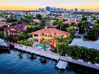 Best value. Elegant waterfront estate. Best waterway & street-underground utilities. Bright, impeccably maintained. New roof & landscaping. Impact windows. Mahogany front door. 2-story Great Room. Second floor landing. Brazilian Cherry floors. Views of pool/waterway. Acoustically designed Theatre, state of the art sound system. Magnificent solid all-mahogany finishes walls. 1st floor has three ensuite bedrooms. Kitchen has 2 sinks, counter bar, eating area pool view. Pass through & door opens to outdoor kitchen. Walk-in pantry & cabana bath adjoin kitchen. Formal dining room. 2nd floor ensuite Guest Room & huge Master Suite, spa tub, separate shower, enclosed toilet area. Heated Pool, Spa waterfall, new diamond bright finish. 90’ dock & 120’ deep waterway. Quick ocean access. Walk to beach Perfect location for a walk to the beach or to the restaurants and shops of Las Olas. Quick ocean access with no fixed bridges.