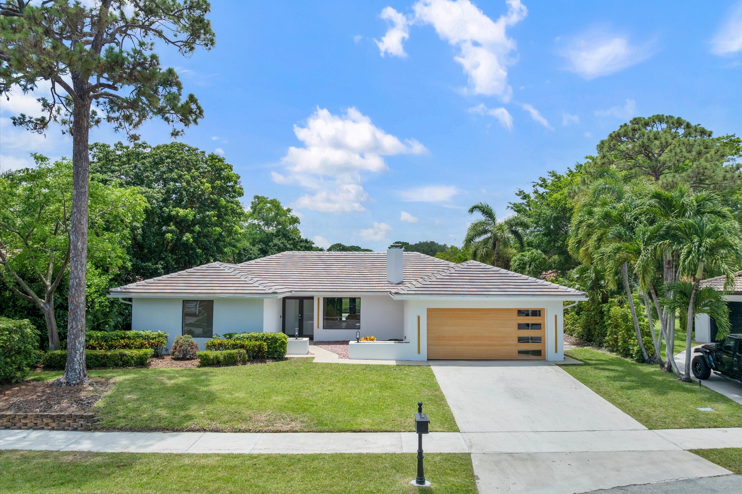 Rarely available cul-de-sac pool home on the lake in Timbercreek.  This fully renovated and tastefully designed 4 bedroom 4 bath home truly checks all the boxes!  New 50 year concrete tile roof (2026), New hurricane impact windows (2026), New hurricane rated garage door (2026), and new air conditioning system (2026).  The open floor plan living space starts in the kitchen with all built in Thermador and Bosch appliances, angular quartz center island and countertops, a walk in pantry closet with full built in organization systems.  A floor to ceiling glass enclosed wine storage closet with LED lighting highlights the elegance and uniqueness of the dining area.  A hidden mud room area with storage, LED overhead lighting in garage, and even a working wood fireplace!  Overlooking the pool  with new Diamond bright coating, imported tile decking system, and art deco style design, the glass enclosed patio is fully air conditioned creating an additional living space perfectly appointed with vented grill and kitchen area, LED lighting, and sliding glass windows and doors.  The list goes on and on in this one of a kind spectacular home in one of the best sections of Timbercreek.  Low HOA, Omni Middle and Spanish River High zoned in central Boca Raton.