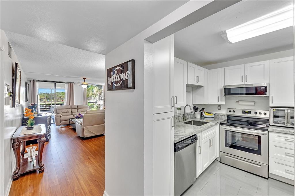 Welcome to Concord Village 9, a sought after community minutes from major highways, shopping, and restaurants, situated on a beautiful golf course. You'll love this large newly renovated corner unit with 2 bedrooms, 2 bathrooms, a large patio, and with more than generous storage. This community also offers 3 pools, clubhouse, community center, plenty of guest parking, and elevators. All ages welcome in this building!! Wi-Fi also included in maintenance fee.