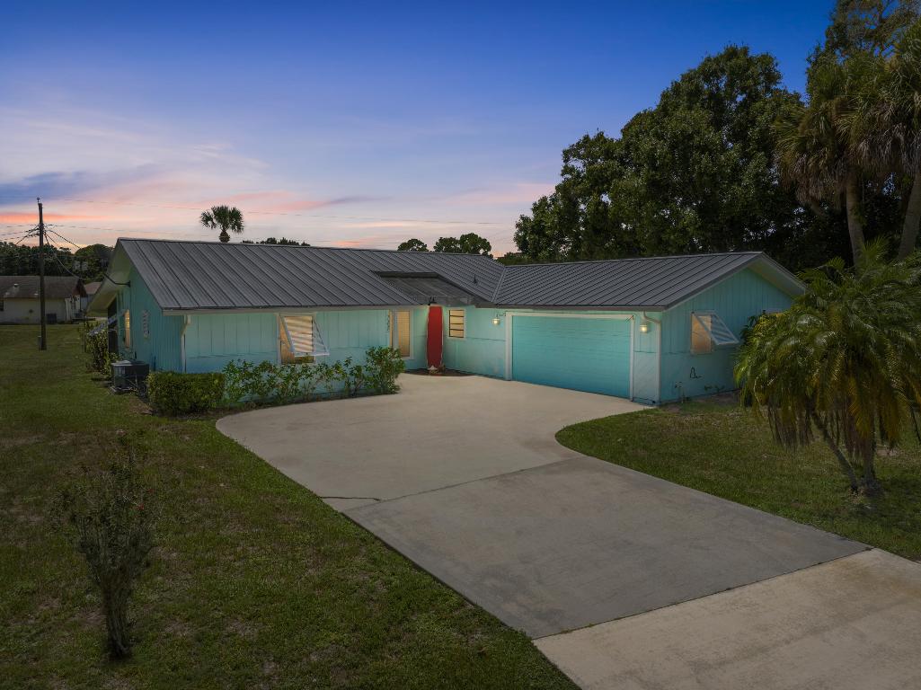 Room for your boat, RV, and more on an oversized corner lot in the desirable Lakewood Park community. This inviting 3-bedroom, 2-bath home plus bonus den, easily convertible to a fourth bedroom, offers comfort, flexibility, and true Florida living. A durable 2018 metal roof, Bahama shutters, and a 2020 AC system provide both style and year-round peace of mind.  Inside, the bright open layout features tile and laminate flooring throughout and a well-appointed kitchen with stainless steel appliances. The private primary suite serves as a relaxing retreat. Step outside to a fully fenced backyard and an expansive 40x10 screened-in patio, perfect for morning coffee, entertaining, or unwinding in the Florida breeze. Located in Lakewood Park, residents enjoy access to community lakes, parks, walking trails, playgrounds, ball fields, and a community pool, all without strict HOA restrictions. Conveniently situated just minutes from shopping, dining, I-95, US-1, and the beaches of Vero Beach and Fort Pierce, this home offers the ideal balance of neighborhood charm and coastal convenience.
