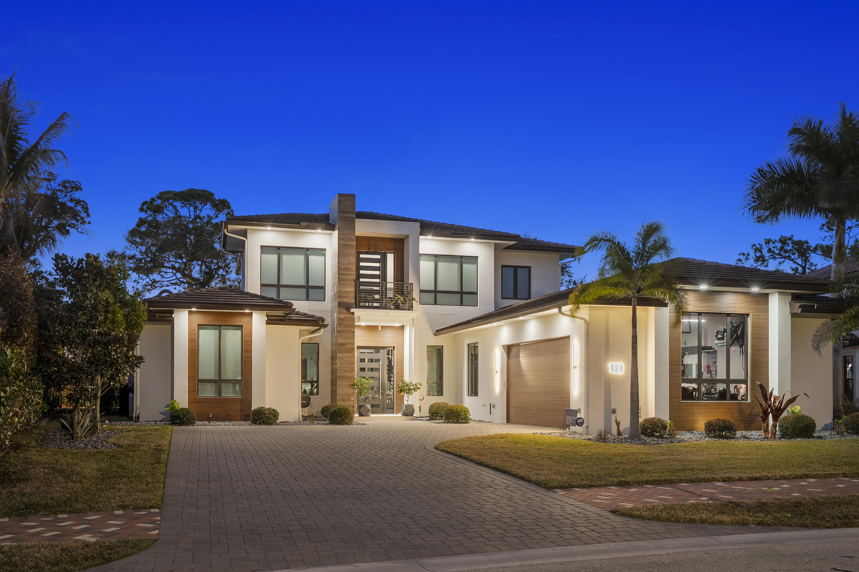 Experience modern waterfront luxury in this stunning contemporary masterpiece with impressive open floor plan and designer upgrades and finishes! This custom-built home showcases a sleek European kitchen with an illuminated quartz island, extra-large Frigidaire refrigeration, and premium finishes throughout. Luxurious master bedroom suite overlooking the water! Indulge in spa-quality details like the illuminated agate shell bathroom countertop and beautifully designed custom closets. With complete impact glass, a striking modern façade, whole-home water softener, and seamless indoor-outdoor living enhanced by roll-down patio screens, comfort meets style at every turn. The backyard is a true boater's paradise-featuring a 20,000 lb lift, 9,000 lb lift, 1,500 lb jet ski lift , and a secure sea wall, all set along a peaceful stretch of riverfront framed by breathtaking sunsets. Resort style waterfront living at its finest!