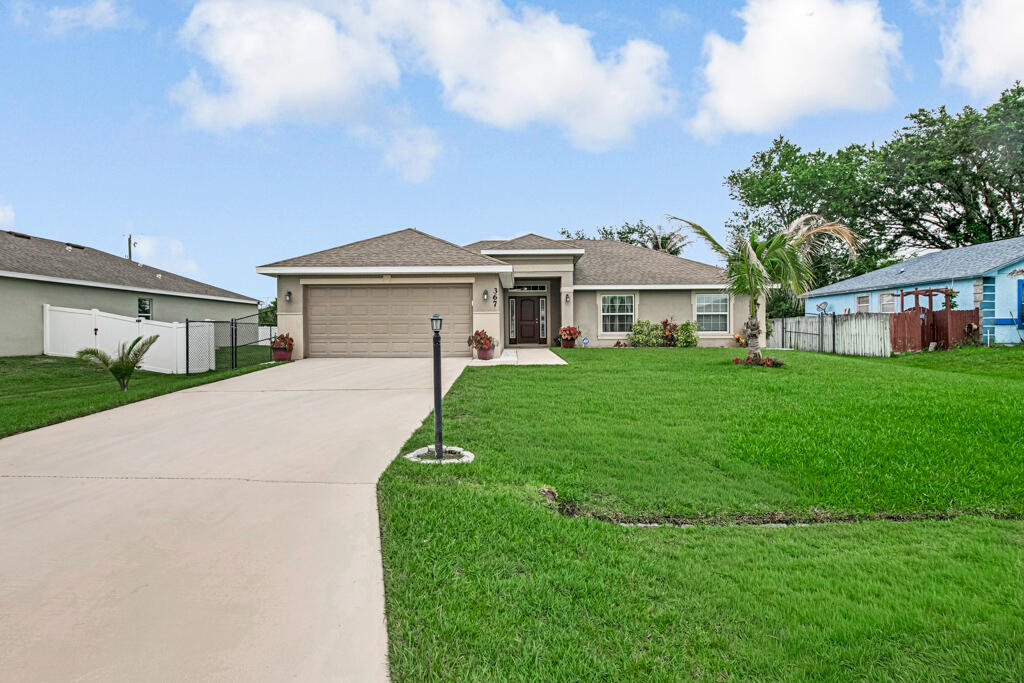 Welcome to this beautiful and spacious 4-bedroom, 2-bathroom home in the heart of Port St. Lucie. Situated on an oversized 10,000 sq. ft. lot, this property offers the perfect blend of comfort, functionality, and outdoor living. Inside, you'll find beautiful vaulted ceilings, abundant natural light, an open-concept layout, and a spacious kitchen with ample cabinetry, pantry, and generous counter space. The oversized primary suite features dual sinks, a walk-in shower, private water closet, linen storage, and generous closet space. Three additional bedrooms offer flexibility for  guests, a home office, gym, or hobbies. Enjoy year-round Florida living from the screened-in porch overlooking the large fenced backyard with fruit trees and plenty of room to entertain, garden, or play. Amp
