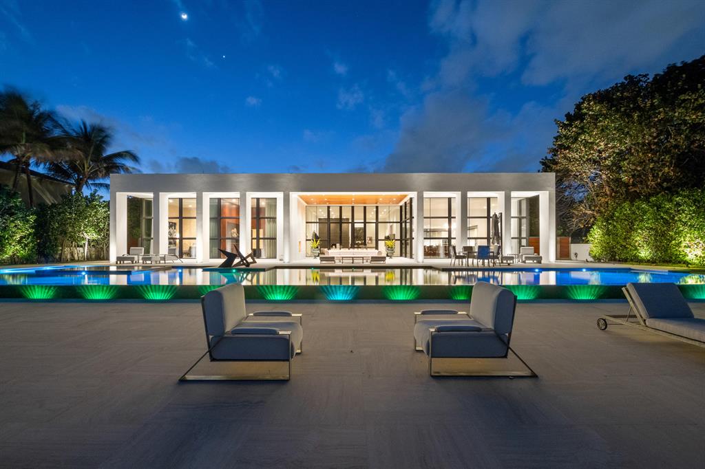One of the finest 'Museum Modern' contemporary Ocean to Intracoastal estate homes in Florida.  With 125 feet of beachfront on the Hillsboro Mile, this one-of-a-kind residence was created to capture stunning sunrise and daytime views of the ocean and the 90 foot infinity edge pool and spa, thru floor-to-ceiling glass windows and 15 foot ceilings.  Located in the ultra safe and secure town of Hillsboro Beach, a private gate open to an elevated stone driveway that leads to a home and site that stretches 385 feet to the ocean. An open glass modern Intracoastal two story/two suite guest house captures 'no wake' yacht travel and magnificent sunsets with its own kitchen, pool, entertainment area and two car garage.  Simply put, a most captivating, inspiring and ultra luxurious estate. See More... Oceanfront Property dimensions:  385 feet deep and 125 feet direct oceanfront
Intracoastal Two Story Guest House: 125 feet of Direct Intracoastal and 100 feet of depth

Minutes to the Lighthouse Point Marina, and a short distance to the Boca Raton and Lighthouse Point inlets.  


The main house has granite and cut coral driveway, that leads to a 3-car garage that would allow for 6 cars using lifts and 2 cars in the guest house. Also has a Kohler power systems generator, it looks to be a majority of the entire house and with 6,000 gallons it should last a lengthy period.
The home is an ultra-modern, geometrically designed with cascading waterfalls and marble slabs that lead you to the front entry. A coquina stone wall waterfall is illuminated by multi-colored lights and there are 6 reflecting pools and 2 cut coral walls with cascading waterfalls. 
The exterior has decorative porcelain cladding and cut coral with white stucco and ultra high-end impact windows. 
Pool patio area has silver travertine marble. The distance from the rear patio area to the ocean sand beach line is about 90 ft. Measure width of property on ocean and intracoastal (126 ft wide) 6 A/C's  Carrier One condenser for the walk-in cooler One carrier unit for the a/c in the garage There are two additional gas-fired hot water systems in the garage. 
There is a back circular staircase of rich hardwood and curved glass leading to the second floor where there is a tv sitting area; off of which there are 4 bedroom-suites. One suite on the SW corner has a sitting area in addition. There is also an elevator on the first floor. There are two half bathrooms near the media room. Two of the four upstairs bedroom suites have balconies, one on the ocean side and one on the intracoastal side. 
There are two sets of Maytag washers / dryers in the utility room where the additional storage area with exceptional closet storage space. 
Kitchen: The cabinetry is Eggersmann, with a finger touch push open system. There is an enclosed bar. The countertops are white onyx. There is a 7 burner stovetop system with a hood, Miele oven with a warmer, microwave, steamer and two Miele coffee/beverage makers. There is a center island which is stainless steel which has the vegetable sink and there is also a lacquered zebra-type wood island area that serves as an additional eating area with 6 chairs, facing the ocean. 
In addition, this also serves as additional storage area. The full back pantry has a desk/sitting area as well as a walk-in refrigerator and extensive pantry storage. 
The interior floors are 3 x 3 squares of silver travertine marble throughout the main areas of the first floor. 
Guest house you go through a gate on the north side that leads into a raised pool area. Pool dimensions of the pool by the guest house are 60 x 16. There is an outdoor barbecue grill. Gorgeous cut coral walls with silver travertine top for the barbecue grill and has a somat shelf with dimensions of about 20 x 15. 
The downstairs living room is 24 x 20. The kitchenette area has the white recycled glass countertop, 5 burner cook top, Miele oven, sub-zero refrigerator, with two sub-zero freezer drawers, Miele dishwasher, hood vent out, automated window treatments as the main house does too. Blackout sun-shade and drapery. Sub-zero mini fridge wine cooler. Powder room downstairs with wall-mounted toilets, custom vanities, and onyx sink. Utility room downstairs has washer/dryer, counter has recycled white glass. The garage is a two car garage but double high, giving you the ability to have lifts in the garage if necessary. And has two Noritz tankless water heating systems. Ceiling height in the downstairs entertainment area is 11 ft. Bedroom upstairs is 18 x 18 with closet space area 
Covered patio on the north side which is 12 x 18 with stunning views of the intracoastal waterway and the tea canal and westerly sunsets. A full bathroom with walk-in shower, bidet water closet. 15 x 15 secondary bedroom upstairs with full bathroom and balcony out on the westerly side to the intracoastal waterway.
 
There is a vertical 45 ft inlet to park a boat, 13 ft wide. Approx 110 ft length of the boat dock to be able to moor a boat with deep water as well, in excess of 6 ft deep at low tide. Dock has dual power and water station, is referred to as the Admiral SS System. 2 a/c systems, one is being installed today, Carrier and York system.
There is a water purification system, Atlantic filter and a salt-water purification system. There is a Kohler generator for the guest house and a heat pump electric Jandy heater for the pool and a purification system for the pool hidden behind a privacy wall. Currently for the guest house it has parking comfortably for up to 8 cars. Disclosure, the gate cannot be closed off. The Hillsboro has a requirement that movable gates must be 40 feet back from the property line. 
New water and sewer system put in last year, just completed in October 2019, for Hillsboro Beach. Two Propane tanks hold 3,000 gallons apiece, for a total of 6,000 gallons of propane.