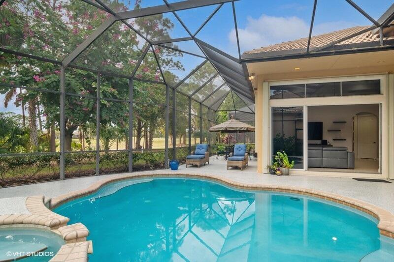 Welcome to your dream home in the exclusive PGA Village! This immaculate 4-bedroom, 4-bathroom home is designed for both comfort and style, featuring a built-in refreshing pool and spa overlooking the lush 7th hole of the PGA Wannamaker Golf Course. In addition to the 4 bedrooms, you have a den/office and a flex room. Formal living room and dining rooms give the extra space needed for entertainment, or for more casual dining you have a breakfast nook and snack bar seating in the open modern kitchen, that over looks a relaxing family room. Don't forget the wet bar for your morning coffee or nightly cocktails. An expansive covered and screened lanai, complete with a built-in BBQ offers the ultimate setting for outdoor dining and relaxation. Other features include a 3-car garage, a 500 gallon propane & a whole house generator for ultimate peace of mind.  This home is designed for those who value luxury, comfort, and premier Florida living. Whether you're looking to entertain or simply enjoy peaceful golf course views, this home has it all! A perfect balance of modern amenities and classic elegance.