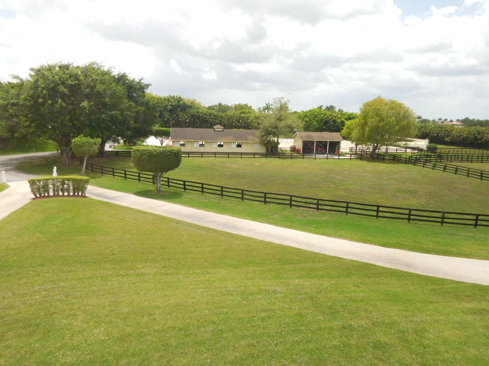 10+ acre working farm on paved Southshore Blvd. 2-story, 7,700+ sq. ft. home with screened courtyard pool and extensive entertainment area. 2 barns - 12 stalls and 5 stalls. Wash racks, grooming stall, grooms apartment, tack and feed. Ring with mirrors. Fenced paddocks.