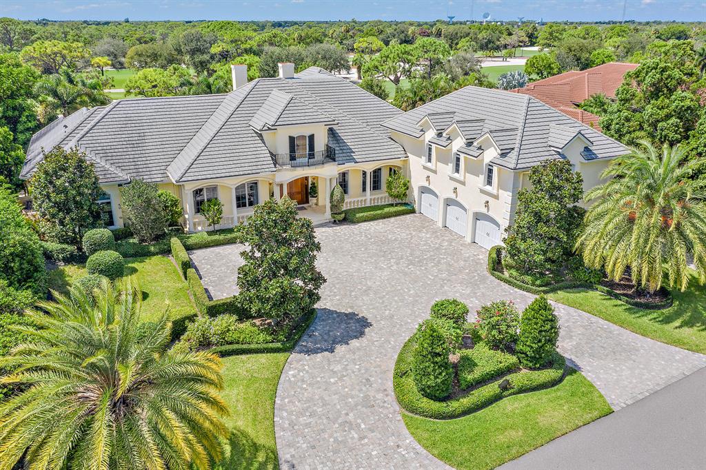 Situated in the heart of prestigious Jupiter Hills Village, this property delivers the pinnacle of indoor and outdoor living.   The grand scale of the windows and doors blur the line between interior and exterior spaces, offering an invitation to the pool, covered terraces and beyond.  An enticing living space designed and built with family and friends in mind.  The outdoor bar with fireplace presents a gathering space to be enjoyed in every season.  The family room flows to a well-equipped kitchen, perfect for the home chef and compliments the outdoor living spaces. If entertaining in a more formal manner, the exquisite dining room, adjacent wet bar and wine cellar complete the entertainment offering of this sophisticated home. The indulgent yet soothing owner's wing boasts a massage room, his and her baths and large walk in closets.  An exercise room and master laundry round out the space.  Access to the pool and jacuzzi after your massage makes for the perfect afternoon.   Two additional bedroom suites are located on the first level as well as a music room and richly paneled office.   For the guests who won't leave, there is a notable bedroom suite on the second level with bonus room and morning bar. The exemplary mechanicals of this home include a full house generator, electronic shades and window coverings, multi zone HVAC systems and impact rated windows and doors.  This desirable home offers over 7,000 square feet of air-conditioned space and will not disappoint the most fastidious buyers. One-time HOA capital contribution of $10,000 due at closing. Membership does not convey.