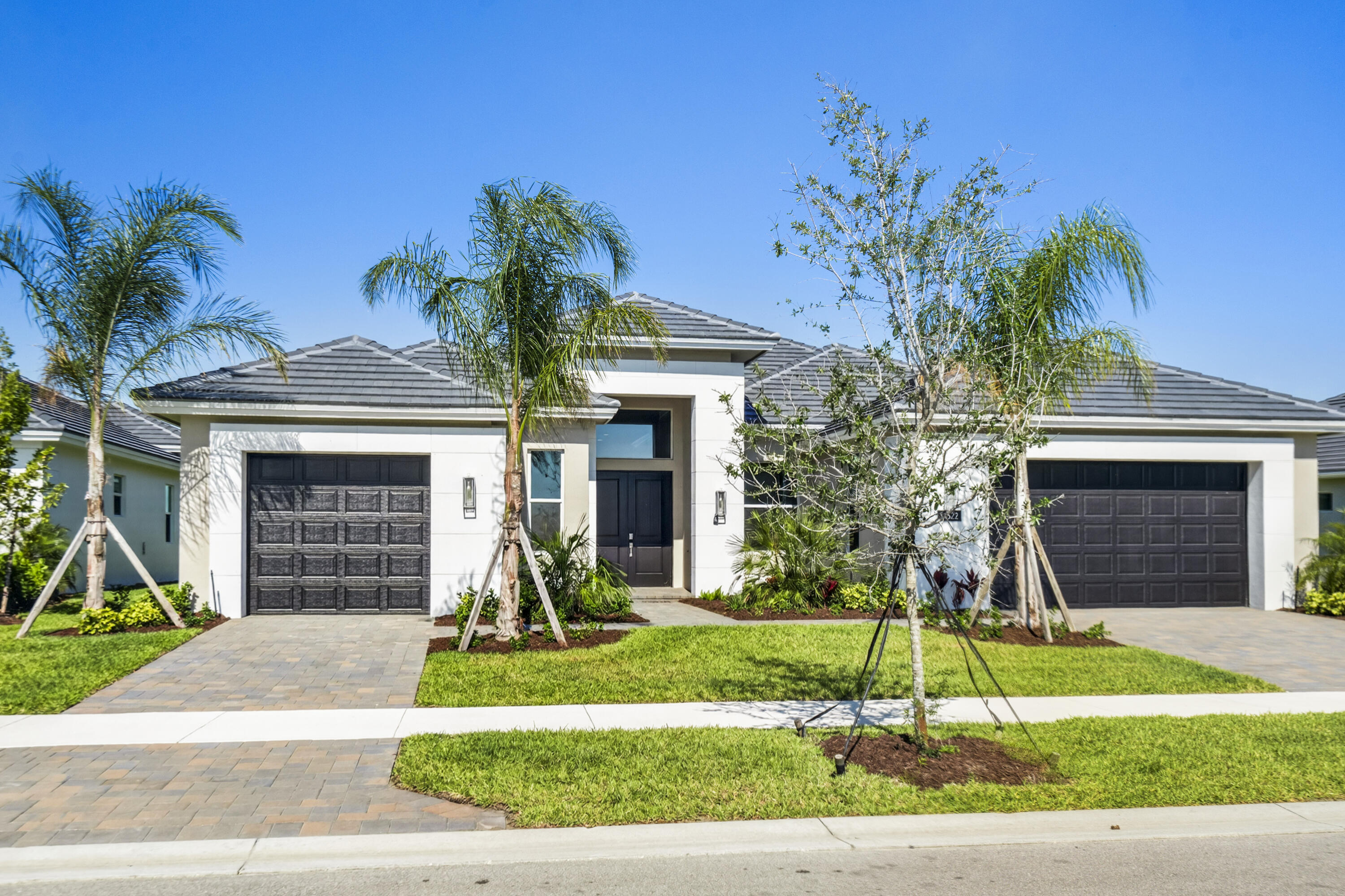This elegant 4-bedroom, 3.5-bath, 3-car garage home in BELTERRA in Tradition features the community's largest and newest floorplan, offering over 3,100 square feet of thoughtfully designed living space. The interior showcases porcelain wood-plank tile throughout, creating a seamless and stylish foundation. The island kitchen is complete with a decorative backsplash and upgraded GE Profile appliances. The open-concept great room, master suite, and bedroom 2 all provide direct access to the outdoor living area. Perfect for entertaining or relaxing, the screened deck has been expanded to include a pool with sun shelf and bubbler, all while offering tranquil lakefront views.