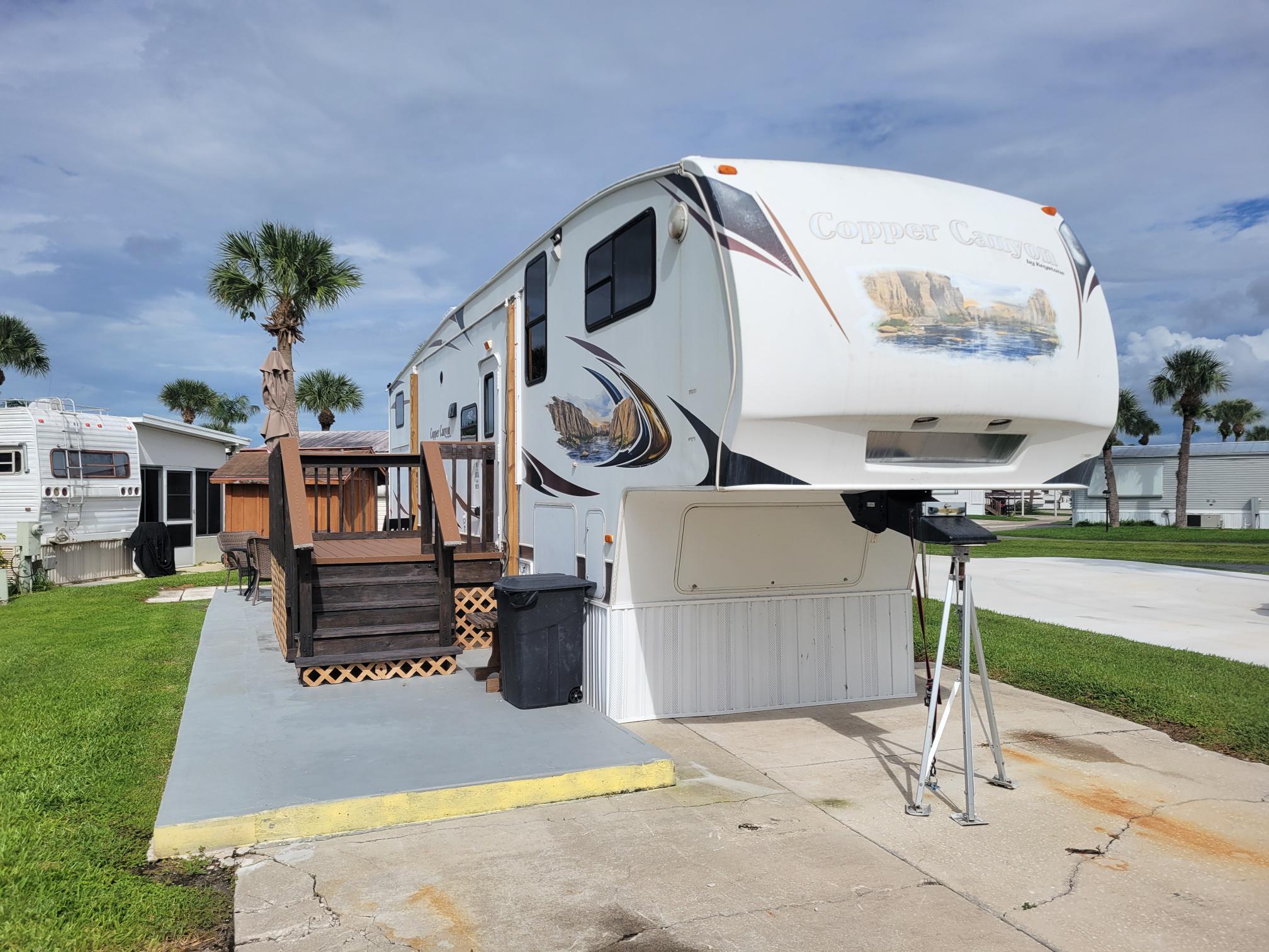 Presenting a well-maintained fifth-wheel residence within the desirable, 55+ Ancient Oaks RV Resort. This affordable option offers a low-maintenance lifestyle, featuring recent upgrades including a new A/C system and updated roof, complemented by an outdoor kitchen area. The community provides extensive amenities such as a clubhouse, pickleball courts, dedicated dog walks, and water access with a ramp and docks. Inquire today to schedule a private viewing.