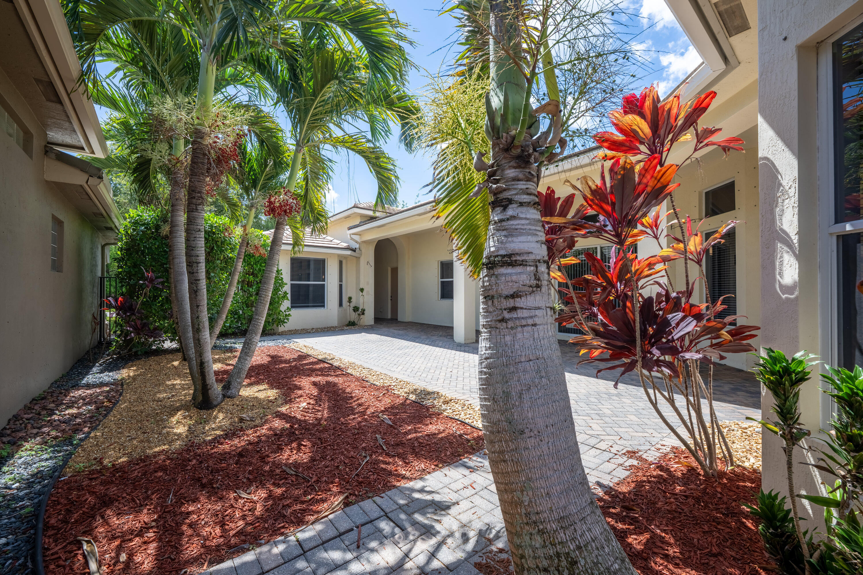 Welcome to the beautiful gated community of Osprey Isles in Palm Beach Gardens. This spacious courtyard-style home that offers comfort, privacy, and an exceptional layout perfect for families or working professionals. Featuring 4 bedrooms and 2 expansive living rooms, this home includes a flexible room that can easily be used as a home office. The separate in-law suite offers additional privacy and versatility for guests, Inside, you'll find a beautifully updated kitchen, spacious master bedroom, and a bright open layout throughout. The home also includes a two-car garage with parking for up to four vehicles total. Lawn care is included. enjoy a beautifully maintained gated community with tennis courts, a playground, scenic lakes, and peaceful nature walking paths.