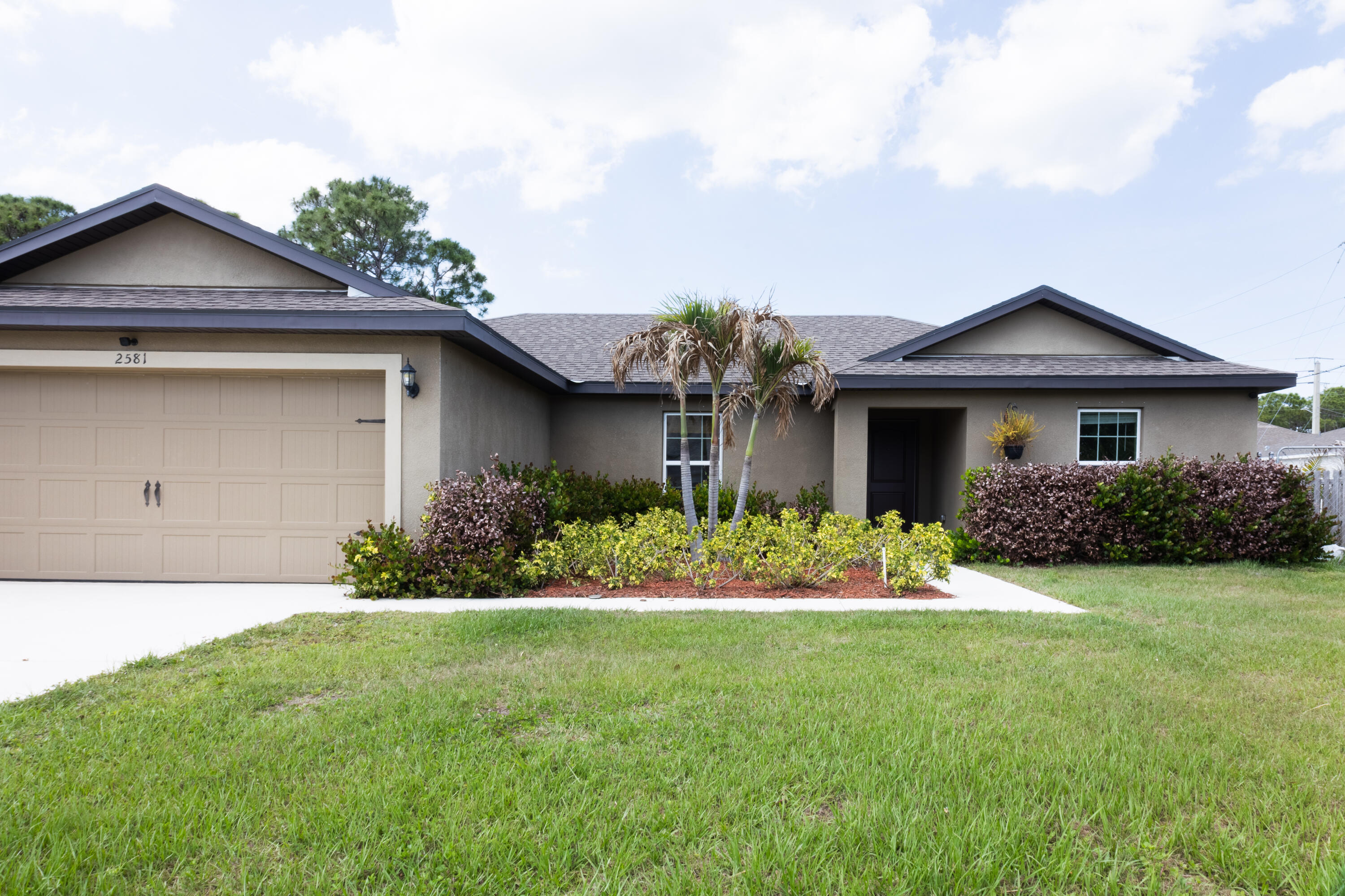 Move-in ready and built in 2022, this beautifully maintained 3-bedroom, 2-bath home offers modern style, comfort, and convenience in the heart of Port St. Lucie. Featuring an open split-bedroom floor plan, the home includes a bright living area, spacious dining space, and a well-appointed kitchen with a large island, pantry, granite countertops, rich wood cabinetry, and energy-efficient stainless steel appliances. The private primary suite offers a walk-in closet and en-suite bath, while the additional bedrooms provide flexibility for family, guests, or a home office. Tile flooring throughout, central air, ceiling fans, a dedicated laundry room, oversized backyard, covered entry, and attached 2-car garage complete this beautiful home. Schedule your private showing today before it's gone!