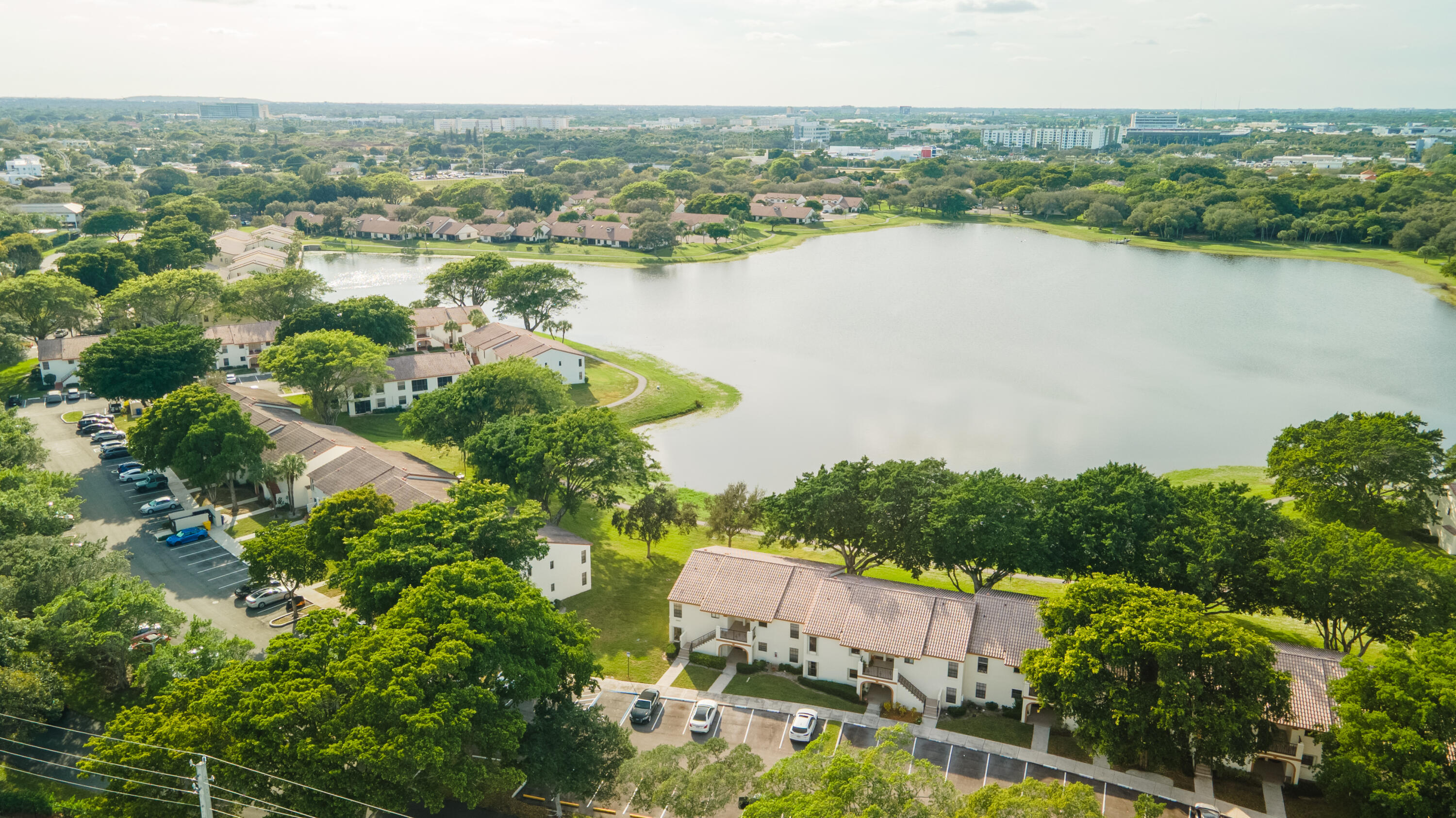 Discover the perfect blend of comfort, style, and location in this stunning end unit, perched in the highly desirable Windwood community of Boca Raton. From the moment you step inside, you're greeted by an abundance of natural light streaming through extra windows, highlighting the breathtaking panoramic lake views that make this home truly exceptional. Many updates include—brand-new appliances, fresh paint, sleek new flooring, and a modern vanity—so all you need to do is unpack and start living your best life. The open and airy layout creates a warm, inviting vibe, perfect for relaxing or entertaining. But it's not just the home that will win you over—Windwood's unbeatable location is the cherry on top. Just minutes from Florida Atlantic University (FAU),   it's an ideal fit for students, faculty, or anyone who values convenience. Love exploring? Downtown Boca's buzzing restaurants, nightlife, and shops are a quick drive away, as are the Town Center Mall, Baptist Hospital, I-95, and Boca's postcard-worthy beaches. Inside the community, unwind with tranquil walking paths, a sparkling pool, and courts for tennis and pickleball. This is more than a home; it's your ticket to the ultimate Boca lifestyle. Don't miss out—come see it for yourself!