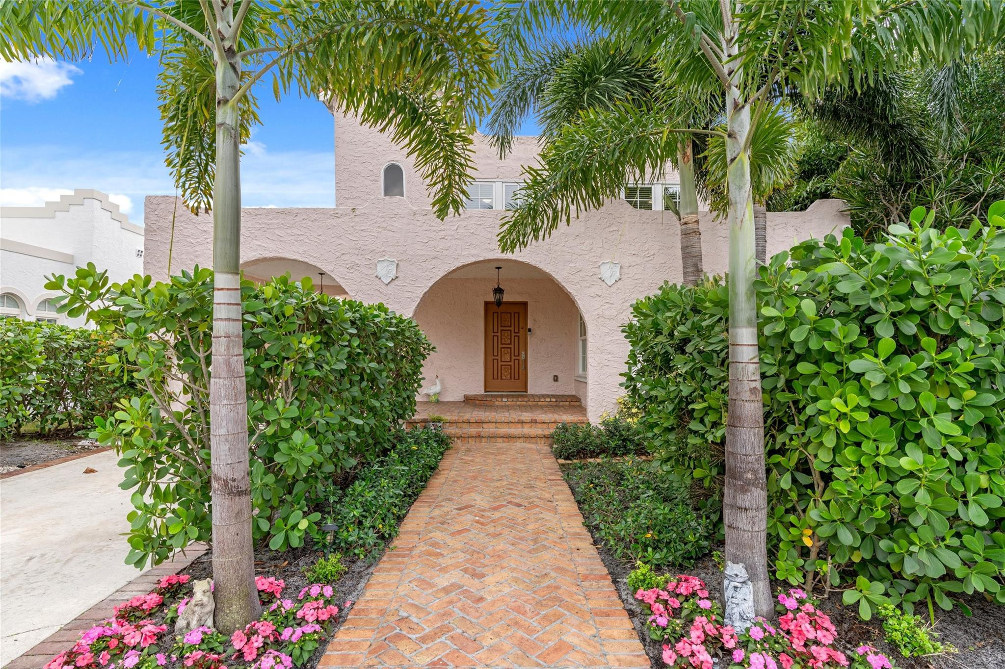 Built in 1925, this historic residence has been thoughtfully renovated to preserve its architectural integrity while incorporating refined modern updates. Located in College Park, the property includes a main residence and a guest house. Major improvements completed in 2022 include a new kitchen with Bosch and JennAir appliances, custom cabinetry, decorative shelving, marble center island and elegant crown molding. Additional upgrades include new bath and flooring, impact windows and doors, new HVAC, and new roof for the main house. The private grounds feature a large heated pool with an expansive pool deck and outdoor pergola. Conveniently located near Palm Beach with easy access to Lake Worth Beach including great restaurants and shopping.