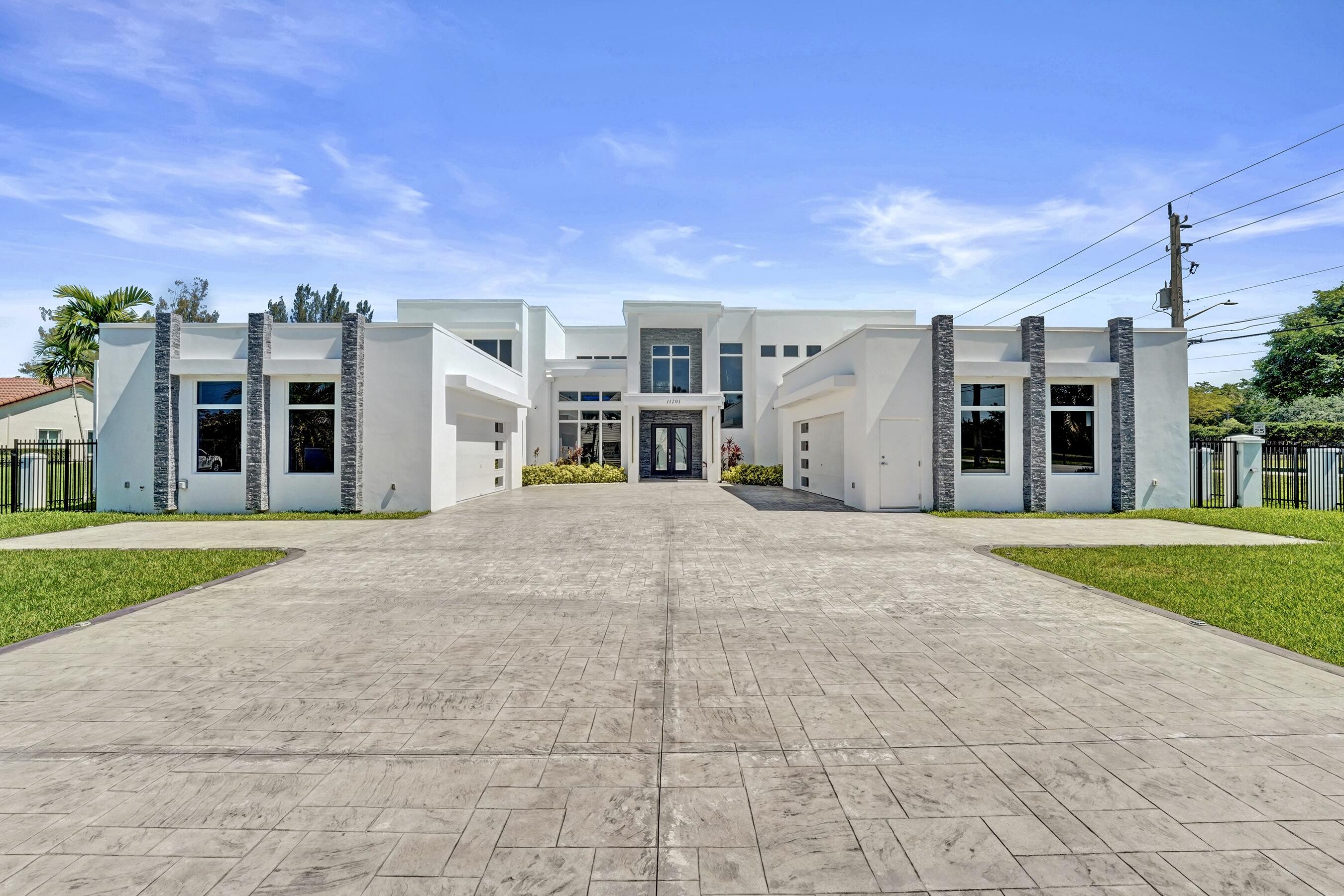 Experience modern luxury in this stunning 2023 custom built pool home on over an acre in Plantation Acres, by Aerial Precast Concrete. This impressive residence features 7 bedrooms, 6.5 bathrooms, 4 car garage, theater room, office, and expansive living spaces throughout. The open concept layout is filled with natural light, high ceilings, sleek finishes, and seamless indoor-outdoor living. The fabulous primary suite offers a spa inspired bathroom and generous closet space, while the additional bedrooms provide flexibility for guests, family, or creative spaces. Enjoy your beautiful backyard with saltwater pool, spa, fire pit, and patio area, perfect for relaxing or hosting. This is a wonderful opportunity to own a newer construction precast home built with exceptional quality and design. Precast construction is built to withstand winds of up to 200 MPH, giving you added peace of mind for hurricane season!
