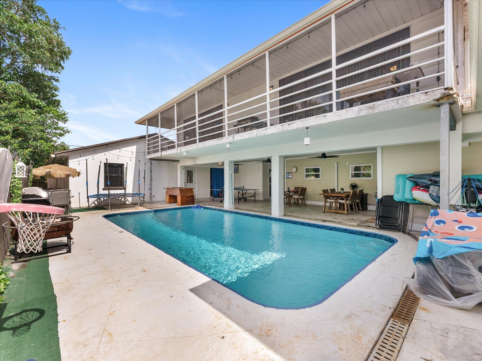 Discover an exceptional opportunity with this recently updated property featuring a 4-bedroom, 2.5-bath main residence plus a separate 2-bedroom, 1-bath mother-in-law suite, ideal for multi-generational living, guests, or flexible use. Two laundry rooms provide added convenience, while the full-length screened balcony overlooks a beautifully centered pool, creating the perfect space for relaxing or entertaining. Zoned for single-family use, this versatile property is ideal as a primary residence, vacation home, or investment. Perfect for buyers seeking an Airbnb-style vacation property (subject to local ordinances and licensing requirements), with excellent flexibility and potential for passive income.