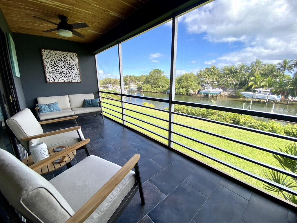 Discover a serene waterfront retreat where refined design meets effortless coastal living. Nestled along the Earman River with dock availability to ocean access, this impeccably renovated 1-bedroom, 1-bath condominium offers a thoughtfully curated living space inspired by exquisite designer finishes. Every detail has been carefully selected, from the elegant tile flooring and recessed LED lighting to the custom accent wall and stylish sliding barn door that add character and sophistication throughout. The kitchen features stainless steel appliances. Bathroom is spa-inspired. The open-concept living space flows effortlessly to a spacious screened lanai overlooking the waterfront where lush tropical landscaping and calming water views provide the perfect backdrop for morning coffee or evening relaxation. Every inch of this move-in-ready condominium has been updated with quality craftsmanship, offering a seamless blend of style and comfort.  River Key is a hidden waterfront gem in North Palm Beach, offering beautifully maintained grounds, a sparkling community pool, storage, and dockage available for lease on a first-come, first-served basis, making it an ideal choice for boating enthusiasts. Conveniently located just minutes from pristine beaches, waterfront dining, world-class golf, shopping, and entertainment, this exceptional residence is equally suited as a full-time home, seasonal escape, or investment opportunity. Modern luxury, timeless design, and waterfront tranquility come together in one remarkable opportunity!