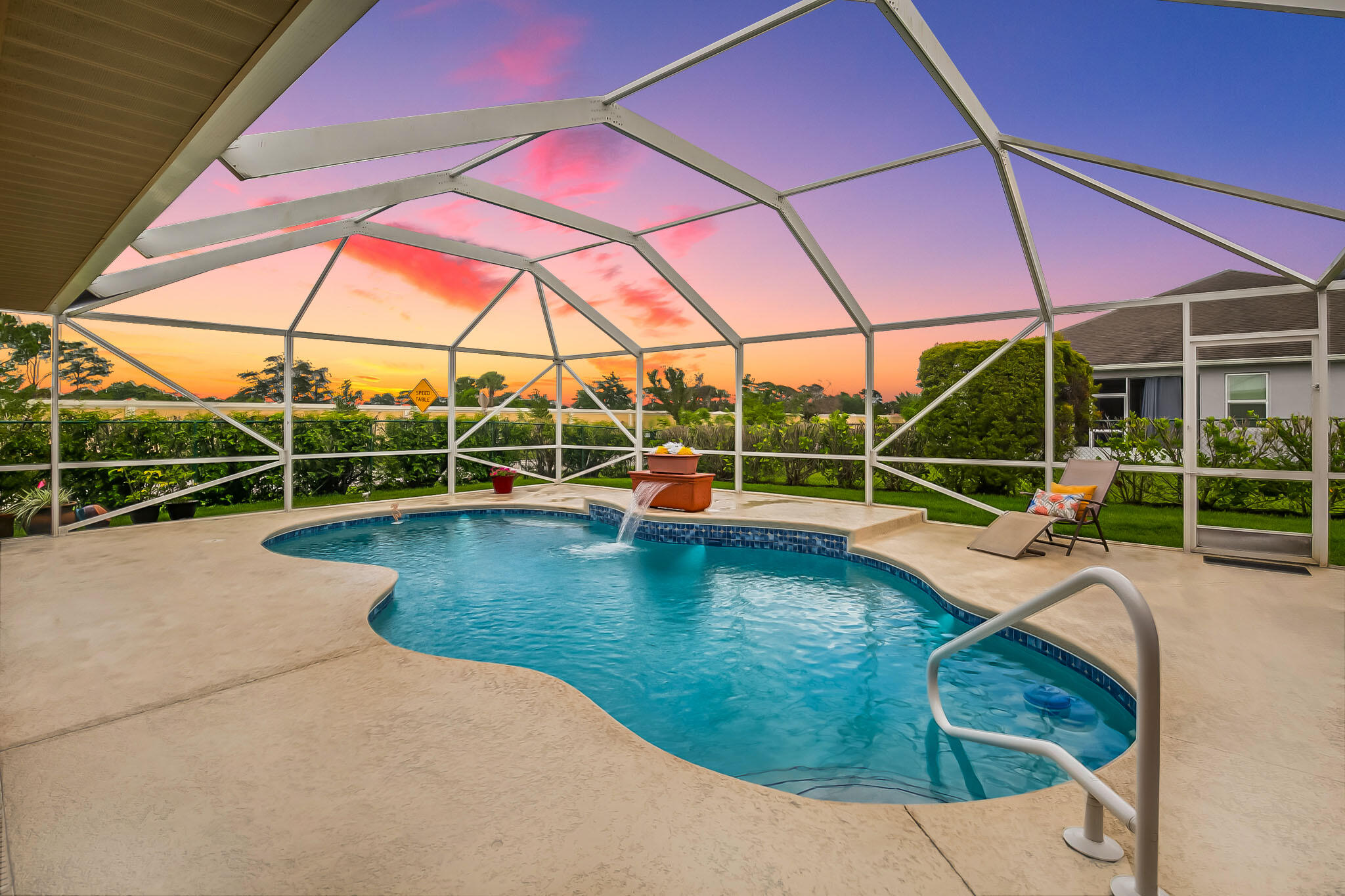 A rare find in one of Florida's most sought after zip codes - this CBS 3BR+den, 2BA pool home provides the convenience & lifestyle of Tradition, without the HOA restrictions & fees. Located on an oversized corner lot, this home offers the space & privacy to live life on your own terms. The tastefully updated kitchen features 42" cabinetry w/ crown molding, granite counters, newer stainless steel appliances, & a convenient pass through window to the pool area - perfect for entertaining. Additional features include wood look tile throughout, large pantry, newer metal roof, flexible office (or 4th bedroom), cozy step down den area, accordion shutters (2022), spacious family & dining rooms, & a fully fenced yard. Unwind in the privacy of your own backyard oasis, complete with an  inground pool w/ waterfall, full screen enclosure, & plenty of yard space to enjoy. Just minutes to Tradition, St. Lucie West, I-95, shopping, dining, & more!