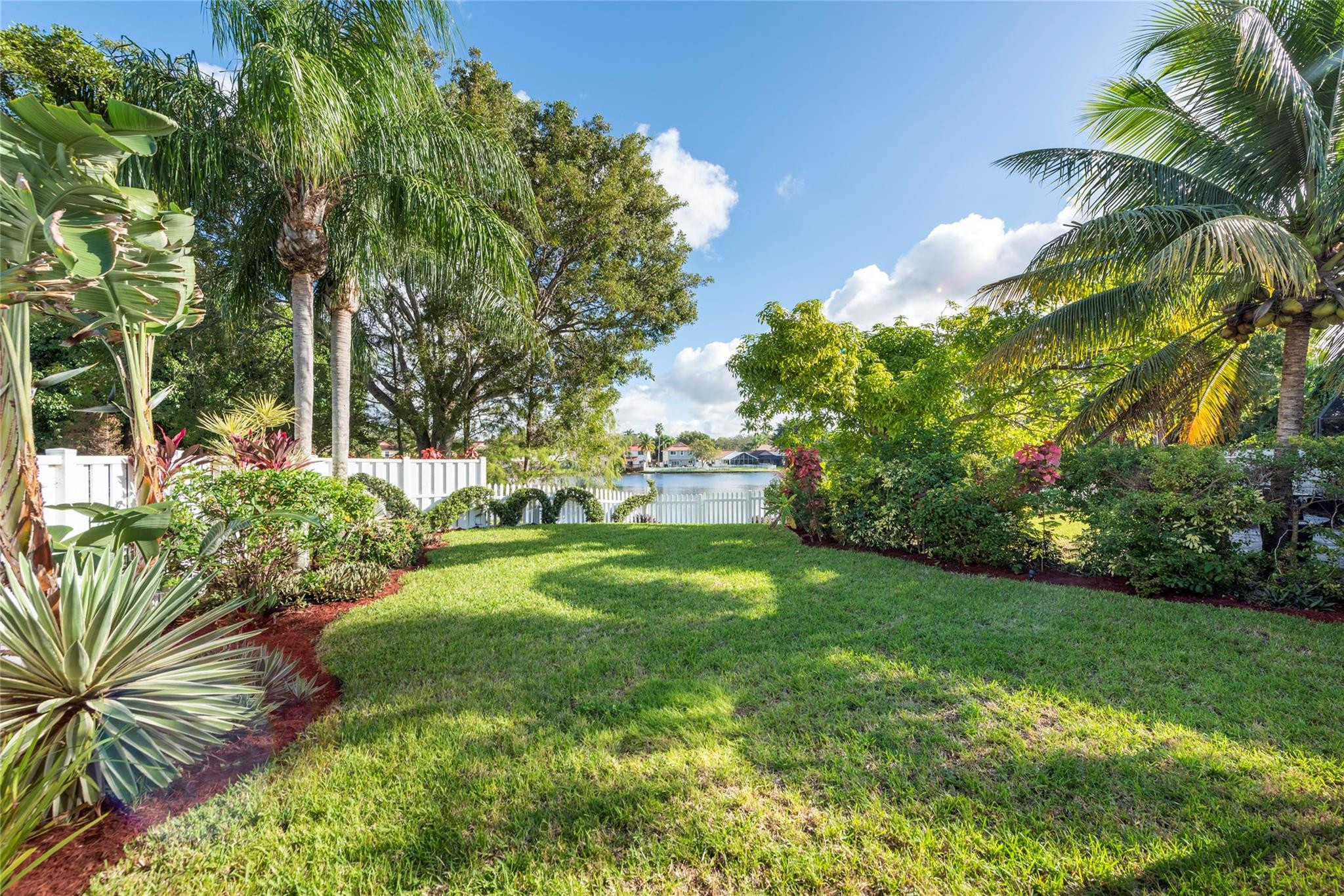 Fabulous 4/2 Plantation Oasis! Large Yard with Serene Lake Views. New Roof (2020), ALL IMPACT Doors/Windows provides peace of mind. Vaulted Ceilings, Open Concept create an inviting ambiance. Kitchen features Quartz Counters, New Stainless Steel Refrigerator, Ample Cabinets, Island with Breakfast Bar. Split Floorplan ensures everyone gets their space. Engineered Wood Floors, Vinyl, Tile. Primary Suite is a true retreat, featuring a Renovated Bath, Dual Sinks, Jacuzzi Tub, Glass-enclosed Shower, and a spacious Walk-in Closet. Tankless WH. Enjoy Your Private Oversized PVC Fenced Yard, Screened Patio. Copper Pipes, Fresh Paint, LED Lighting. Laundry Room. Retractable Awning. 2-car Garage. Guest Parking. 2 Community Pools, Playground, easy access to Shops, Houses of Worship, Restaurants.A Gem!