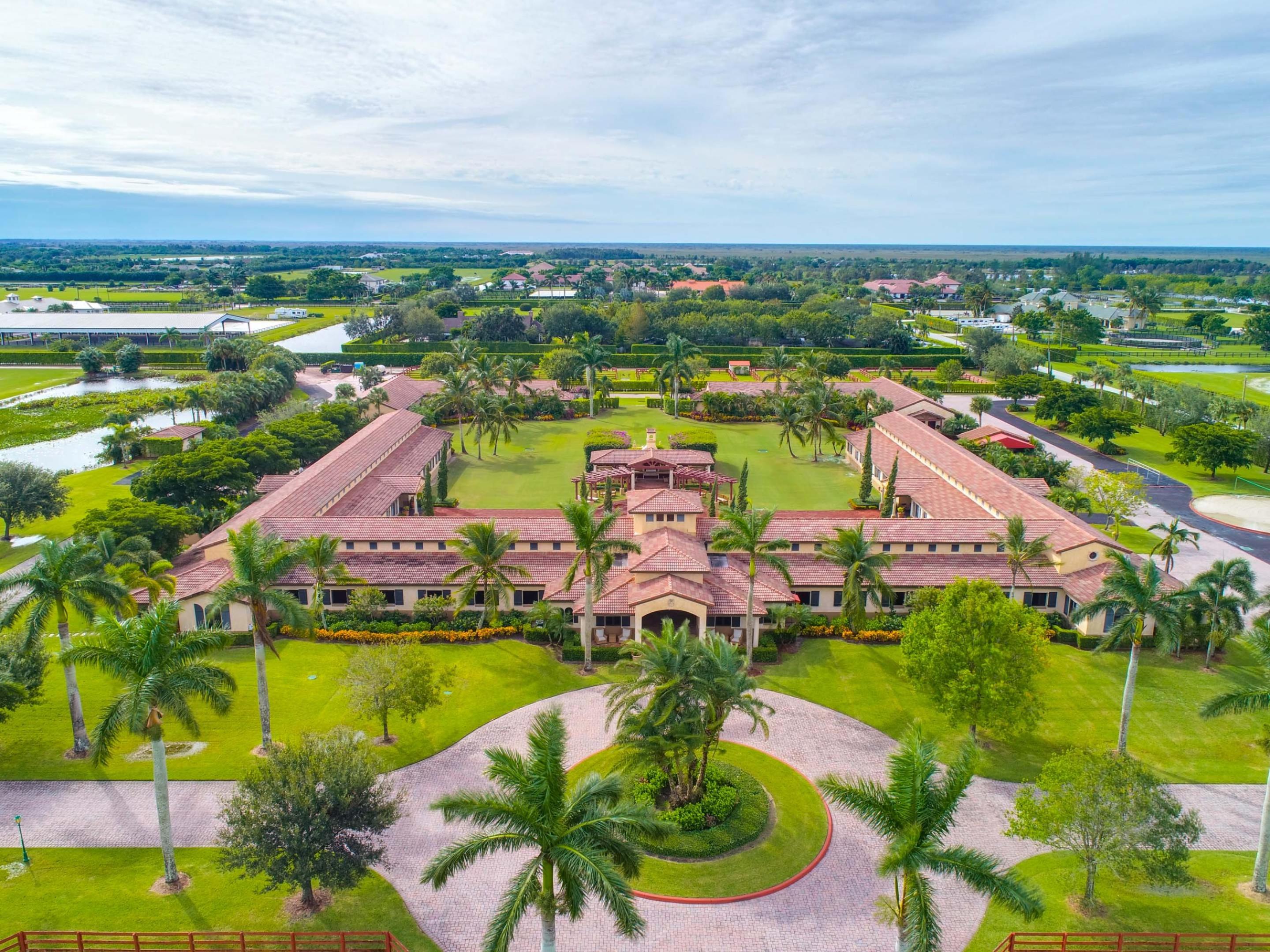 This impeccable 62-acre equestrian compound in heart of Wellington is located within minutes of the Winter Equestrian Festival, Global Dressage Festival, and International Polo Club. Completed in 2005 with top notch facilities for Hunter/Jumper. Polo activities this farm is ready for occupancy.The polo area barn is shaped as a square with 20 stalls in each row for a total of 60 stalls centered around a courtyard with sitting area, summer kitchen and Asado grill. In close proximation are 2 regulation size Polo fields with 1/2 mile exercise track. Celebration Grassland and a grandstand with fitness center & bathrooms. Additional features include 6 tack rooms, 4 feed rooms, wet fly spraying system and aquatic horse walker. Large car collectors garage. For your daily needs the facility includes industrial ADC washer/ dryers.Onsite living quarters for the owner with outdoor terrace and staff area accommodate. 9 apartments with a central kitchen and laundry. Manager's area includes main office with 2 suites, 1 includes storage room for polo side boards, wash racks and 2 sets of conference rooms, 2 bathrooms, laundry area, 1 small separate office. Additional facility attributes include showroom with bathroom, massage cottage, conference room with kitchen, bathroom pantry area.The hunter/ jumper area includes 12-stall barn, 2 feed rooms, 4 wash rooms, 160" x 255" sand ring, 160'x 300' Grand Prix grass ring, 4- 6 horse walker, 16 paddocks. A owners lounge, 1 guest room and 4- staff apartments complete all catering needs. High end car collectors garage.