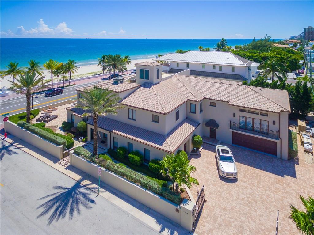 Oceanfront views are enjoyed throughout this gated, private residence located just steps from the beach. This California inspired estate is situated on a large, 15,260 SqFt corner lot with 10,852 SqFt of living space. Enjoy North Atlantic Ocean sunrises from the large master bedroom complete with an office/sitting room/nursery. Oceanfront pool and spacious patio are ideal for entertaining and enjoying the South Florida lifestyle. The formal foyer opens up to a generous living room, dining room, family room and kitchen. Massage room/salon, club room, 6 bedrooms, 6.5 bathrooms, and mother in law suite, complete this impressive estate.